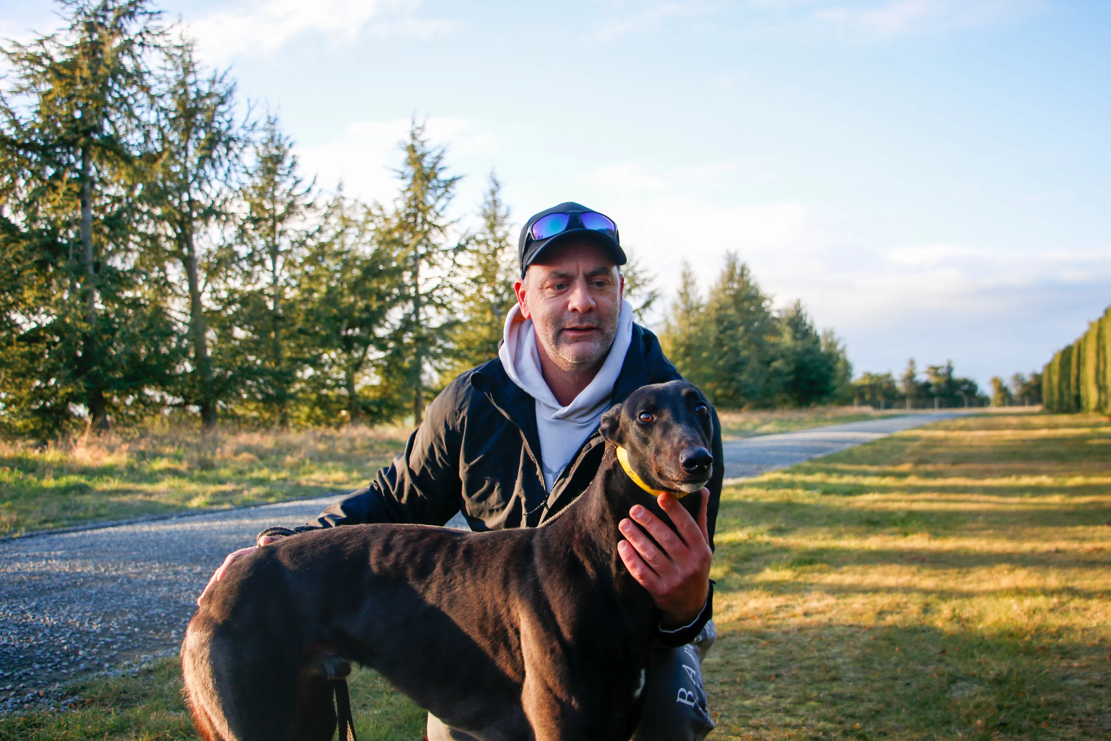 Jonathan McInerney with his dog Sideline Sam, the winner of the last greyhound race at Addington before the industry was closed down. Photo: Daniel Alvey