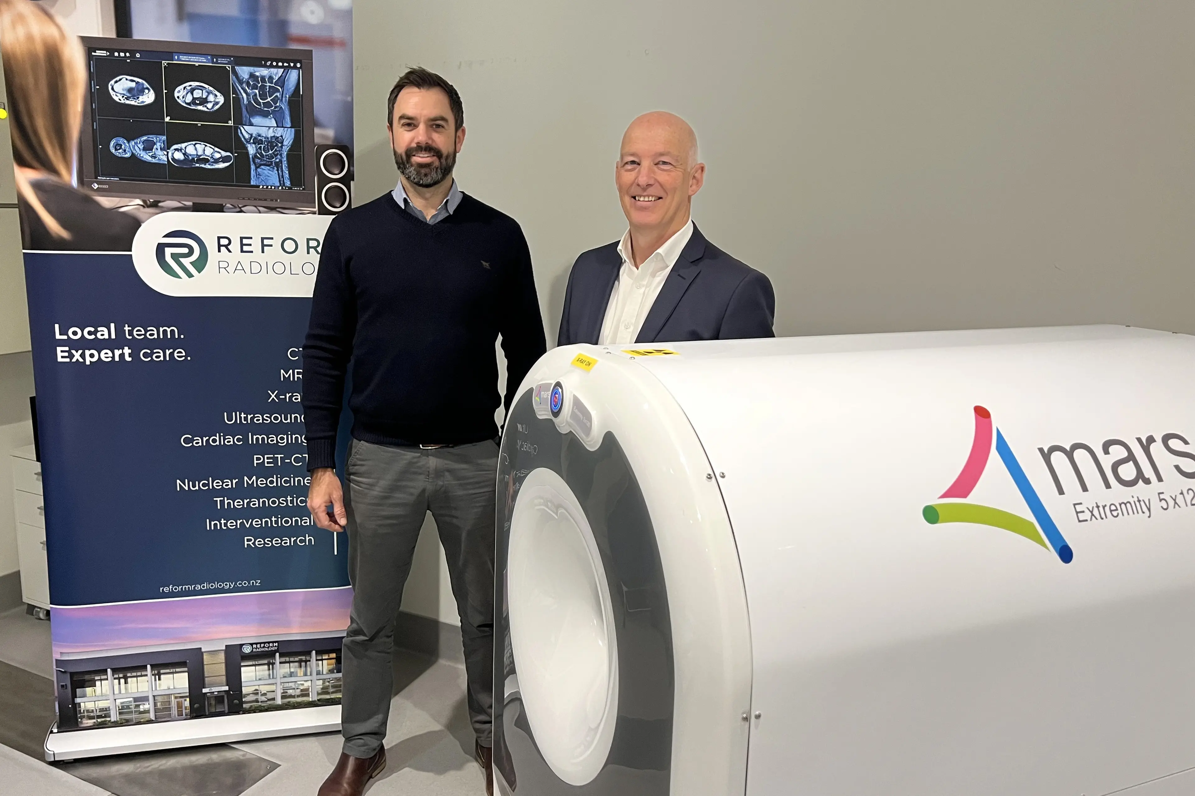 Reform Radiology general manager Paul-Mouthaan, left,\\u00A0and MARS Bioimaging sales vice president\\u00A0Stephen Attkins with the photon-counting CT scanner. Photo: Supplied