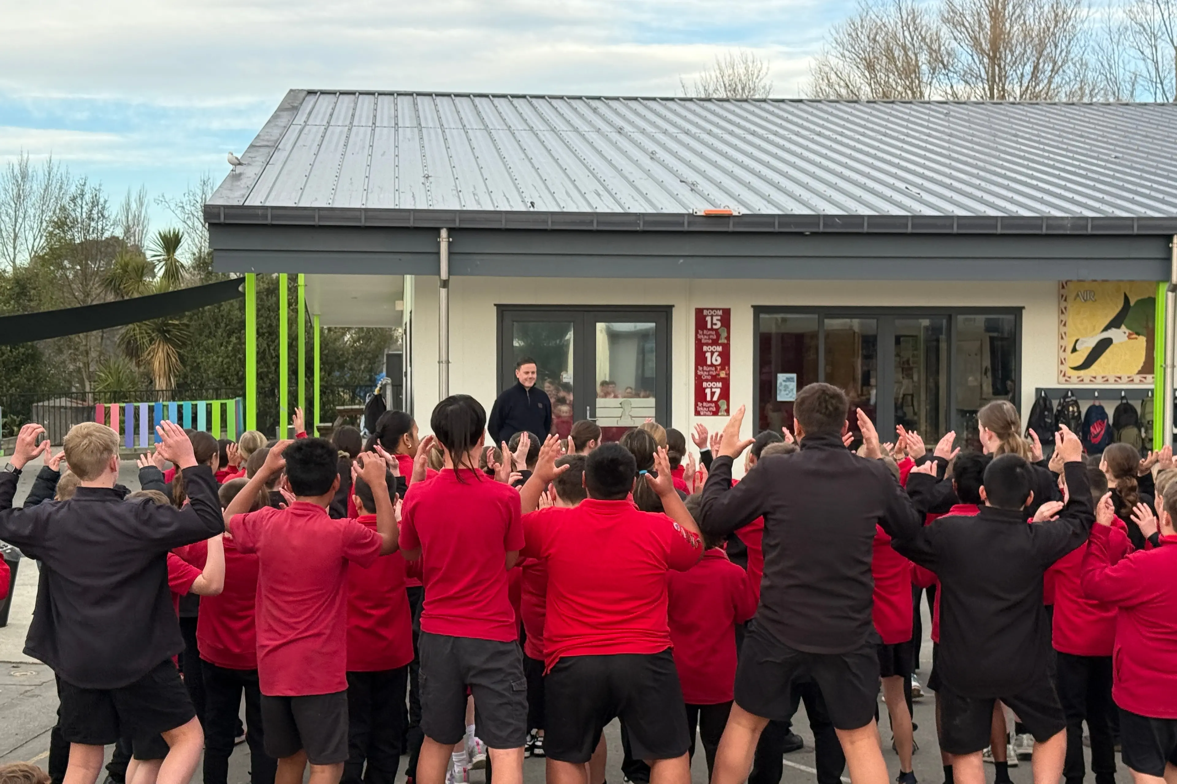 Welcome home . . . Students from Kaiapoi North School welcome back their teacher Hamish Dale, after his successful trip to be the first kiwi to referee at 3x3 Basketball matches at the Glasgow Commonwealth Games. Photo: Supplied