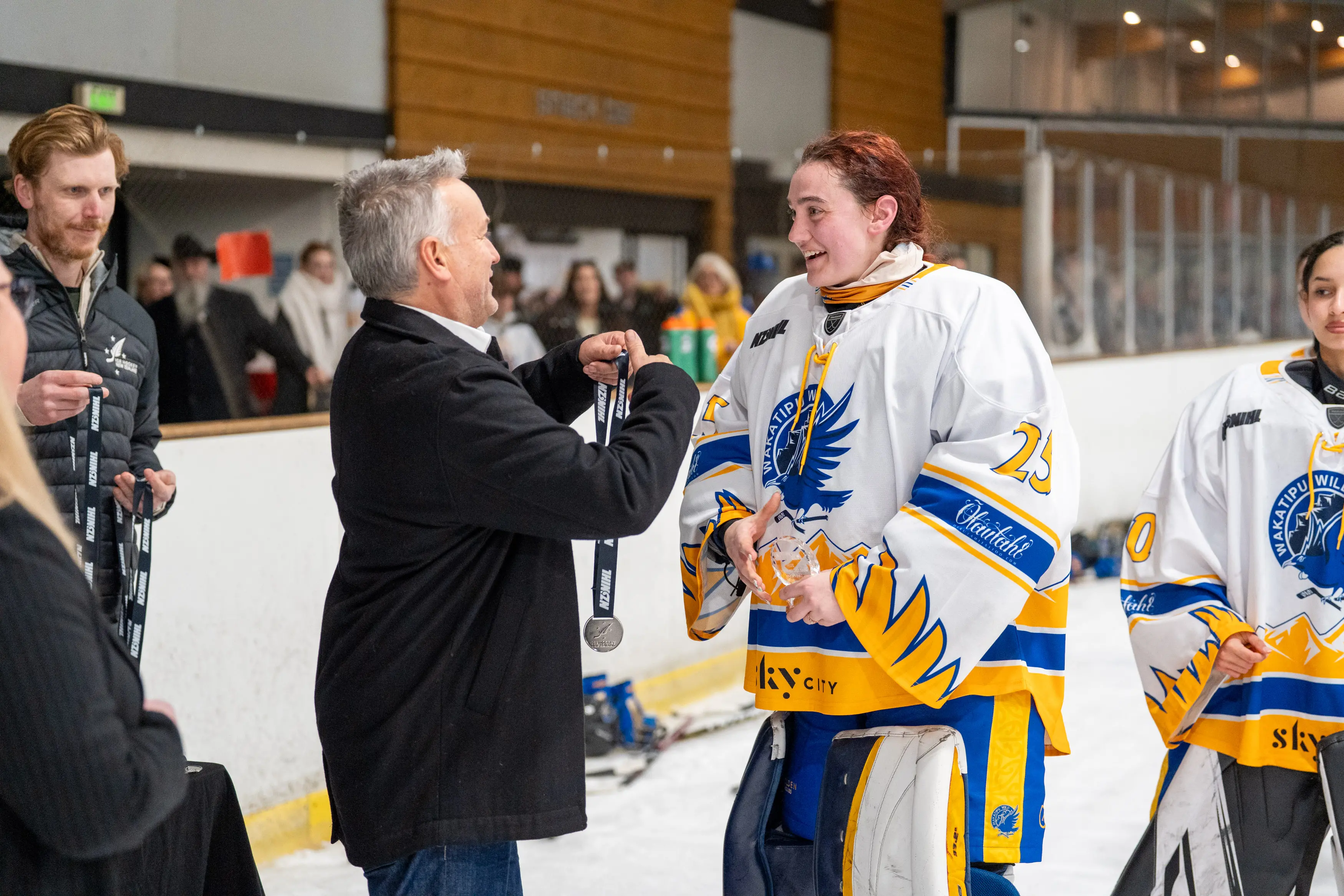 Silver lining: Wakatipu Wild goalie Jordan Wichman receiving her silver medal from Ice Hockey New Zealand president, Arrowtowner Andy Mills. Photo: @GoaliePropaganda