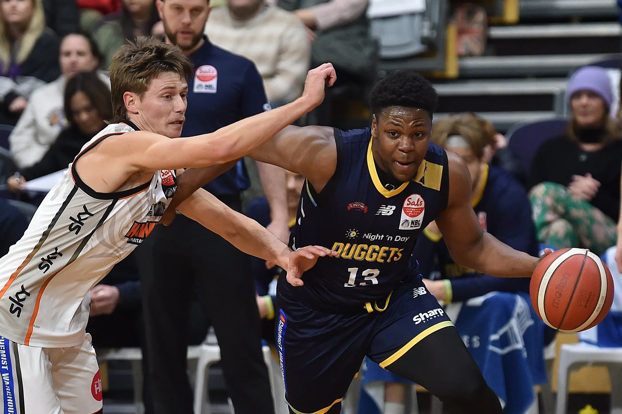 Otago Nuggets point guard Alain Louis slips past Hawks defender Jacob Murphy during an NBL game at the Edgar Centre earlier this season. Photo: Peter McIntosh
