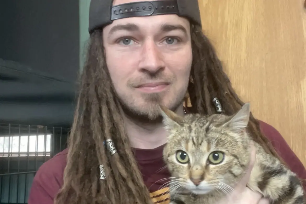 PussN Boots Kitty Rescue member Samuel Bates has a cuddle with the \\u201Cferal\\u201D kitten he rescued from a Lake Tekapo camping spot last week. Photo: Supplied