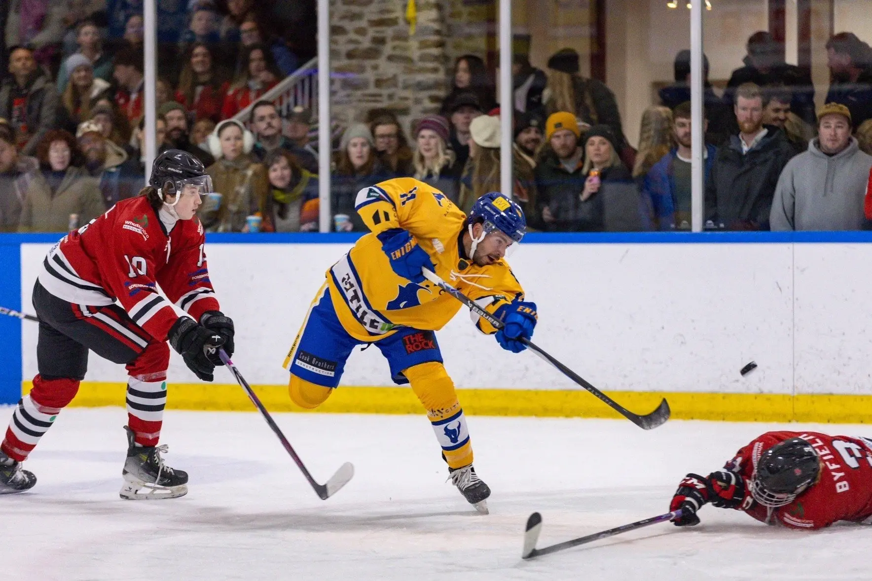 Southern Stampede import Conner Jean flicks the puck between Canterbury Red Devils defenders Harry Campbell (left) and Aaron Byfield during a game earlier this season. Photo: James Allan Photography