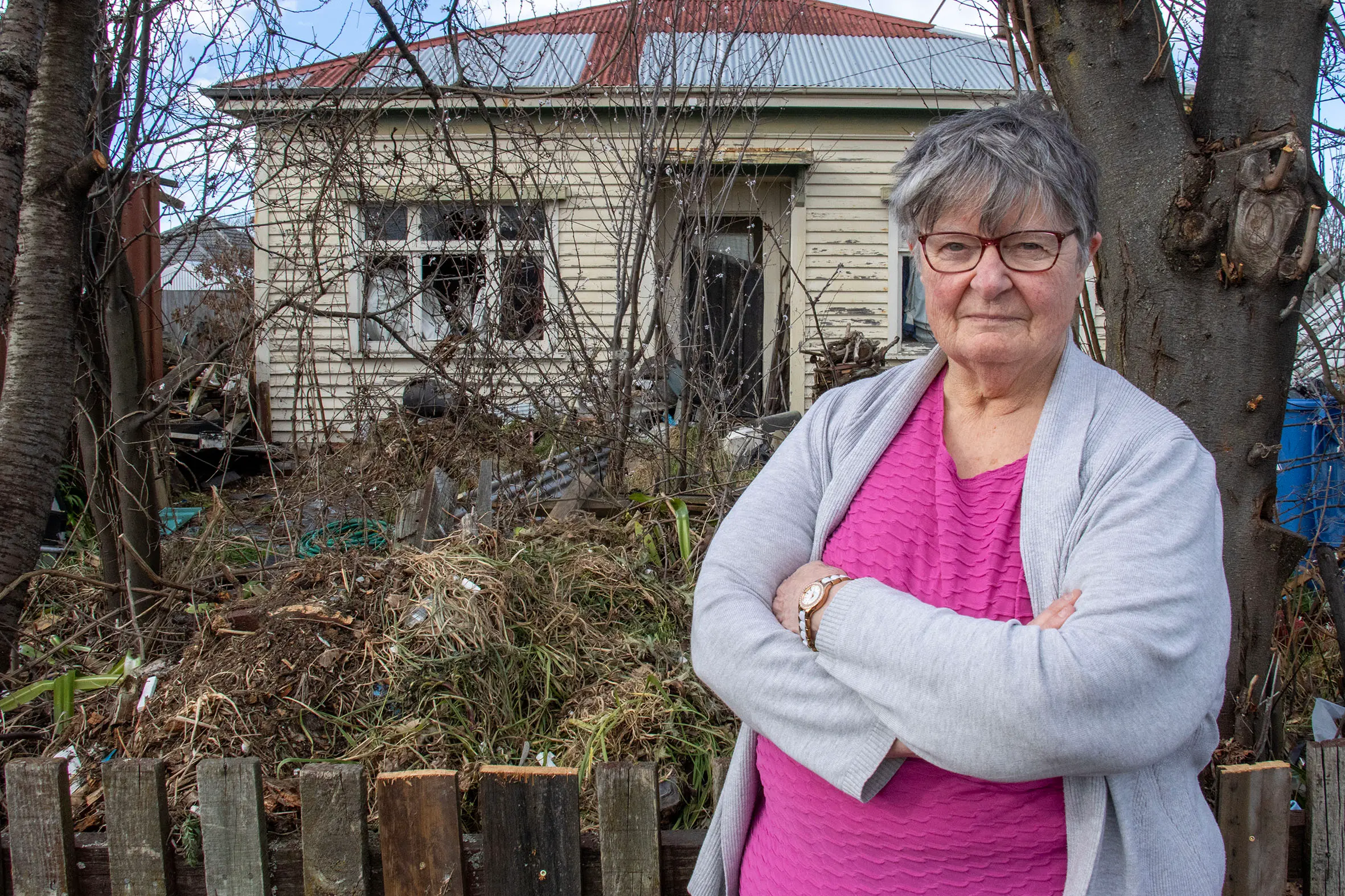 After years of watching a derelict property next door to her deteriorate, rubbish pile up and rats invade her home, Christine Hart is still waiting for someone to act. Photo: Geoff Sloan