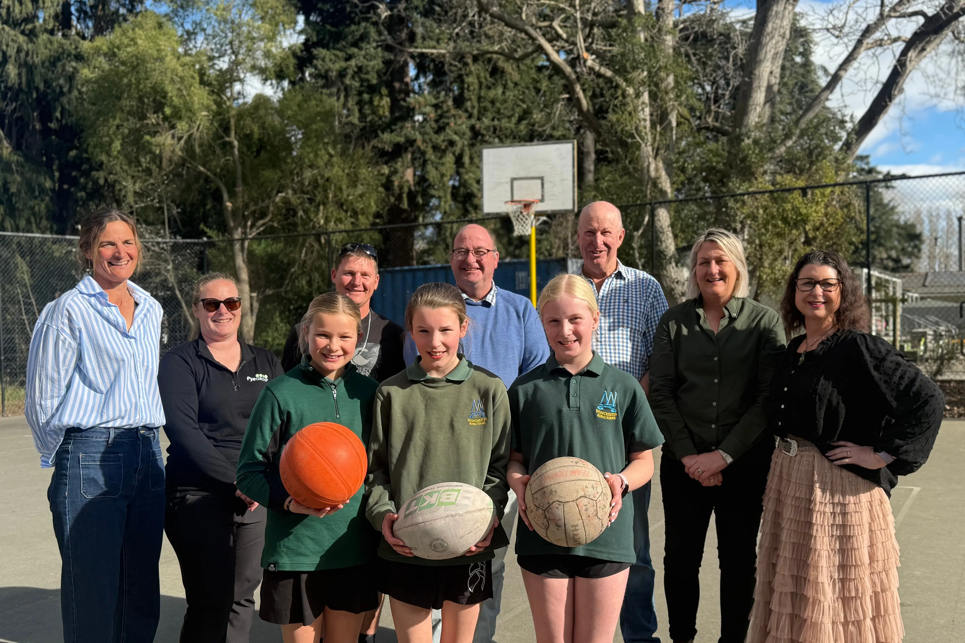 In celebration mode are (back row, from left) Winchester School Turf Project representatives Sarah Portman, Emma Atwill and Matt Catley, Temuka Area Community Fund representatives Charles Scarsbrook, Ian Smith and Michelle Pye, and Kirsty Burnett (Aoraki Foundation) and (front row, from left) Winchester Rural School pupils Brooke Portman, Maeve Forysthe, and Harper Henskes. Photo: Supplied