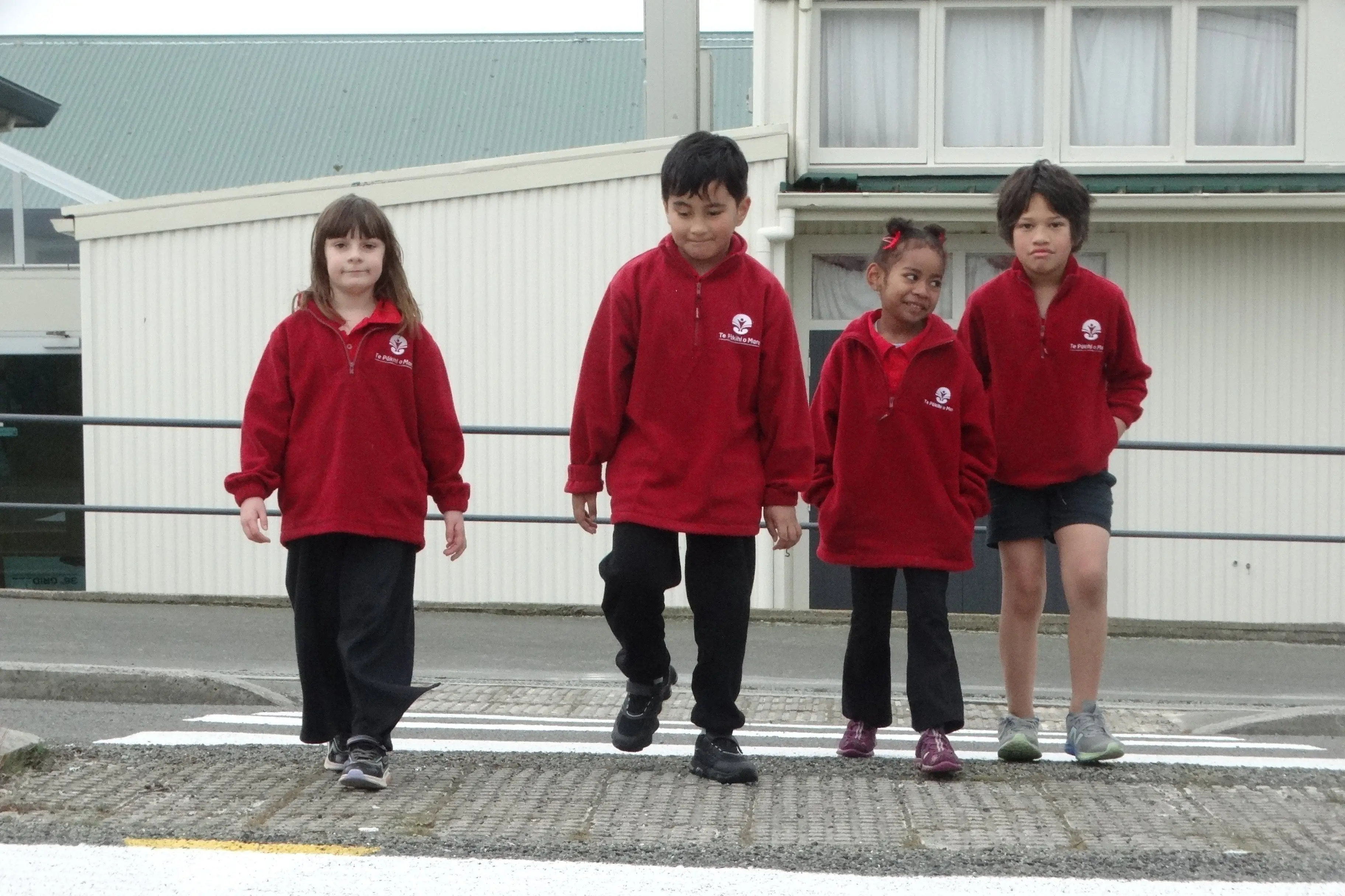 Te P\\u0101kihi o Maru students (from left) Evolet Guy, 9, Karson Fruean, 2, Esita Domonikibau, 5, and Mythias Rangi-Rangi, 9, cross the newly painted pedestrian crossing outside the school on Torridge St. Photo: Nic Duff