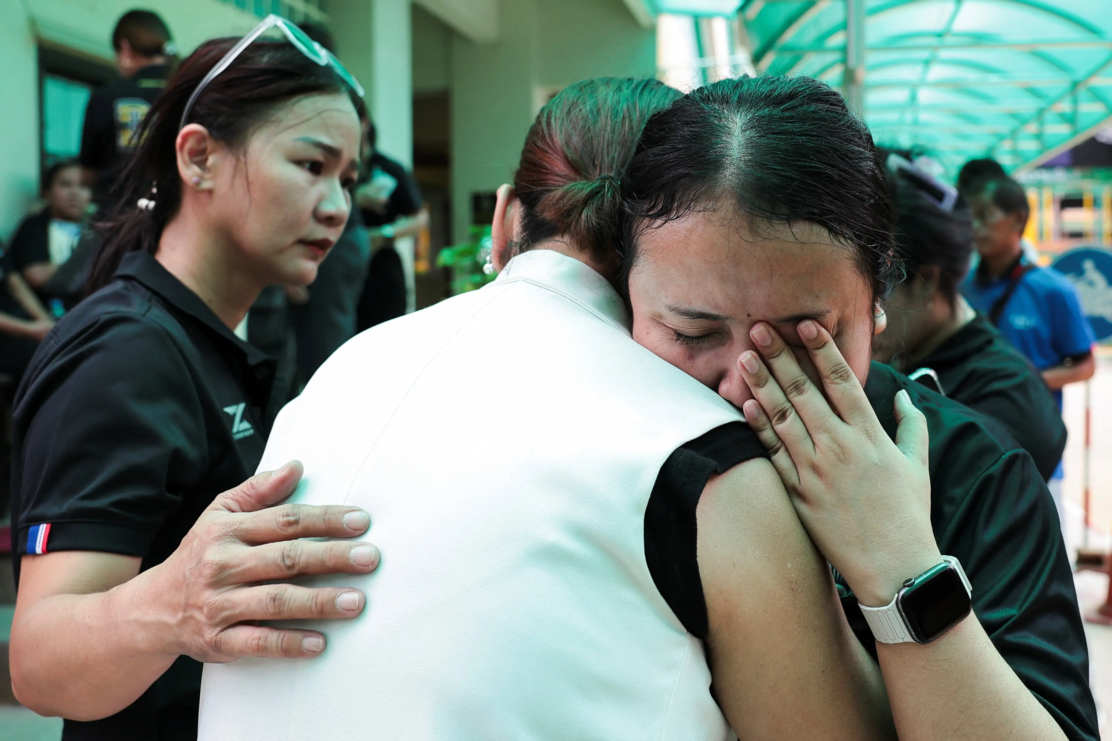 A teacher reacts while embracing a person after the shooting. Photo: Reuters