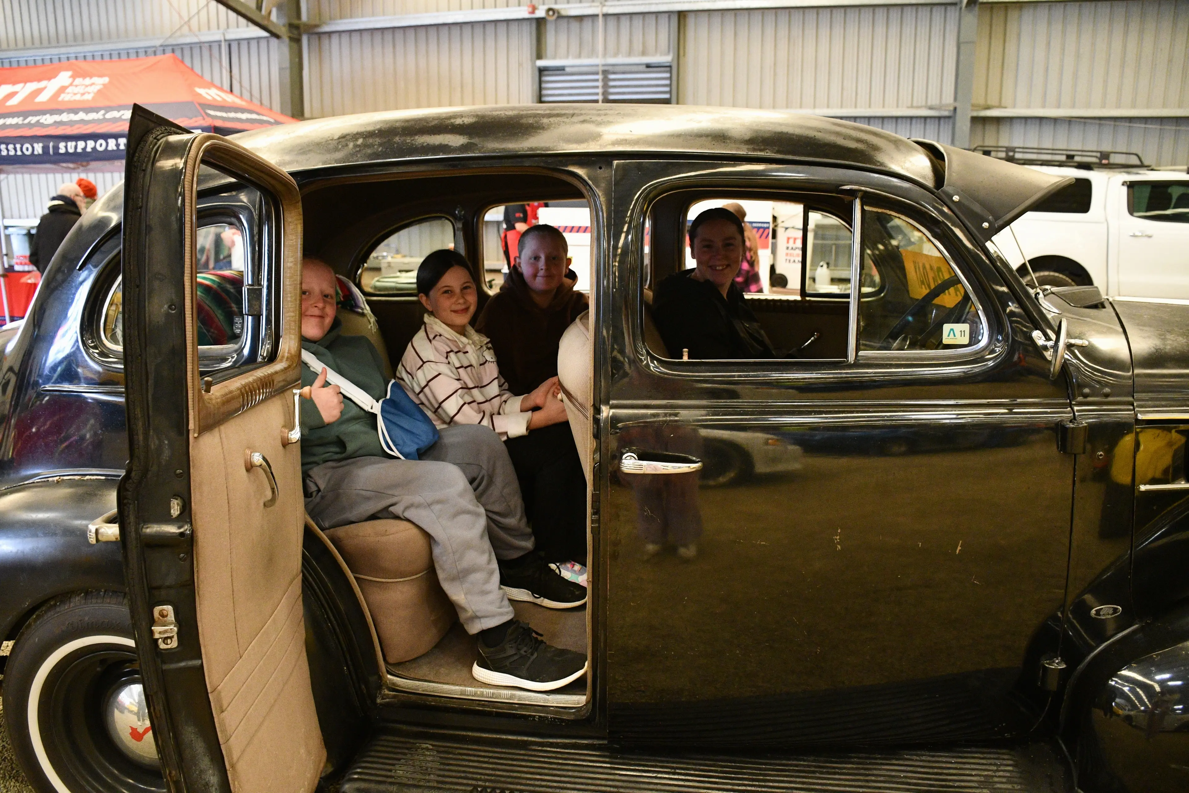 A shiny Pontiac was the ride of Wyndham family (from left) Ryan Turnbull, 13, Stacey Turnbull, 13, Jesse Turnbull, 13, and Ana Turnbull at the annual Hug a Rig event on Saturday. Photo: Gemma Sinclair
