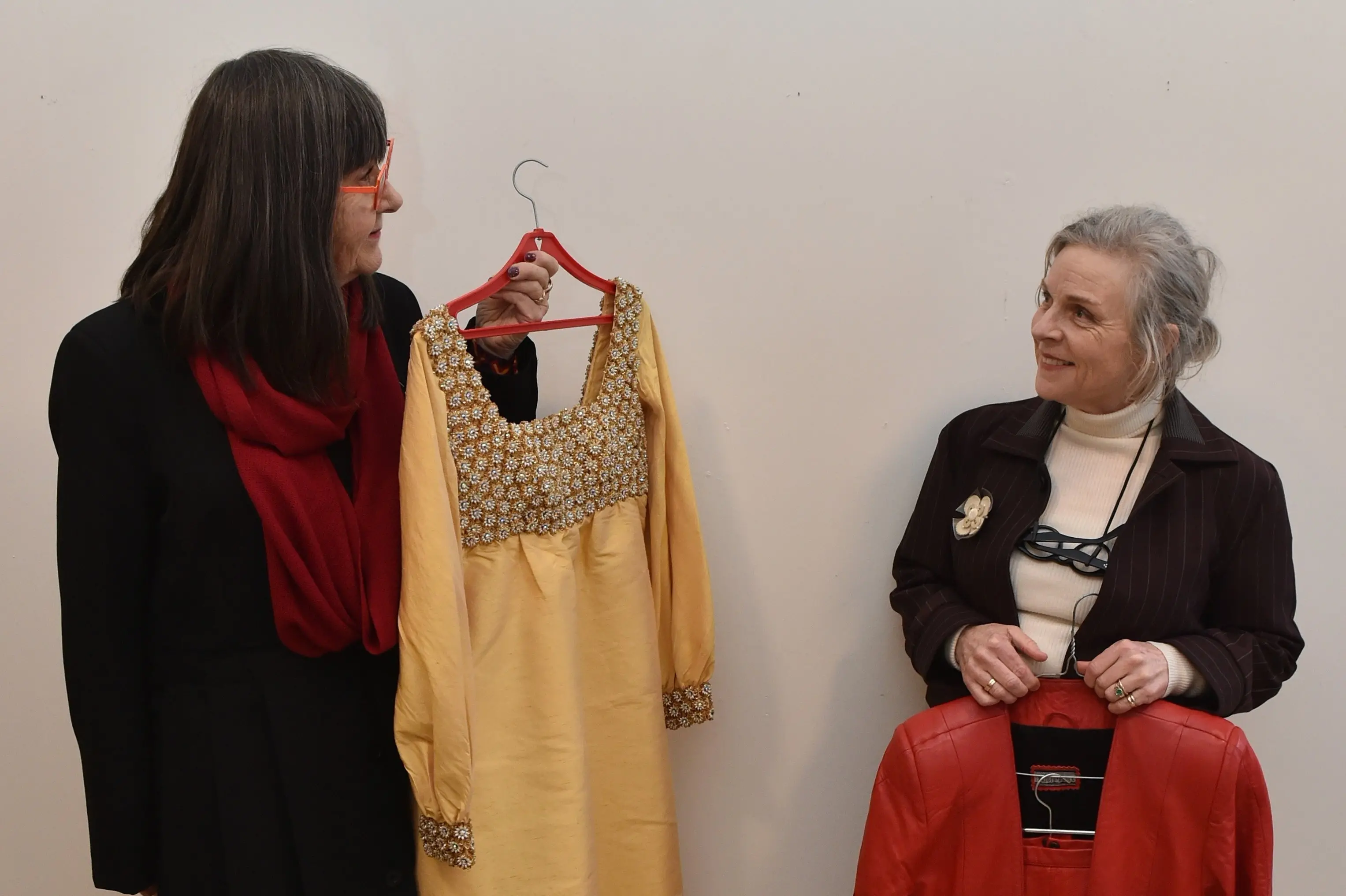 iD board board member and dress historian Dr Jane Malthus (left) with a Lewis Townsend c.1966 in silk shantung, with beaded bodice and cuffs, and co-chairperson Sally McMillan holds her 1980s Brigid Brock leather\\u00A0suit. Both are being shown at the vintage fashion fundraiser archiveD. Photo: Gregor Richardson