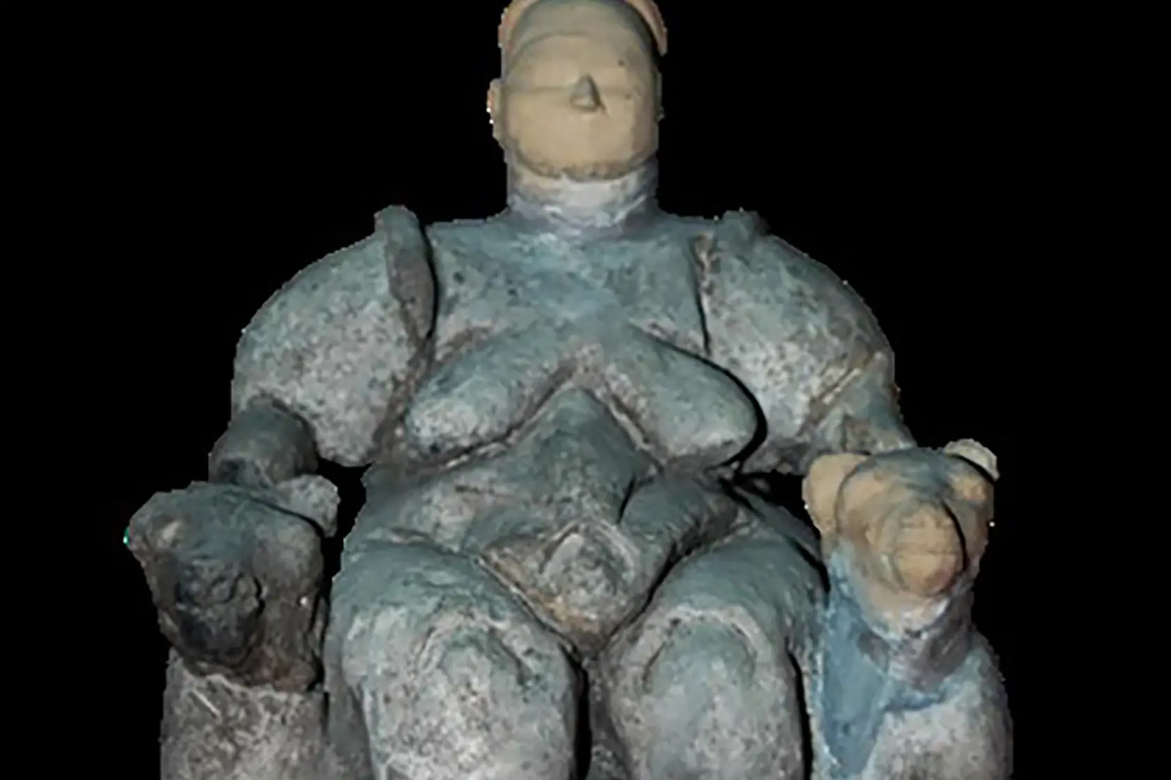 A seated figurine from Catalhoyuk seems to show a woman in childbirth. Her hands rest on carved leopards\\' heads. Photo: Supplied