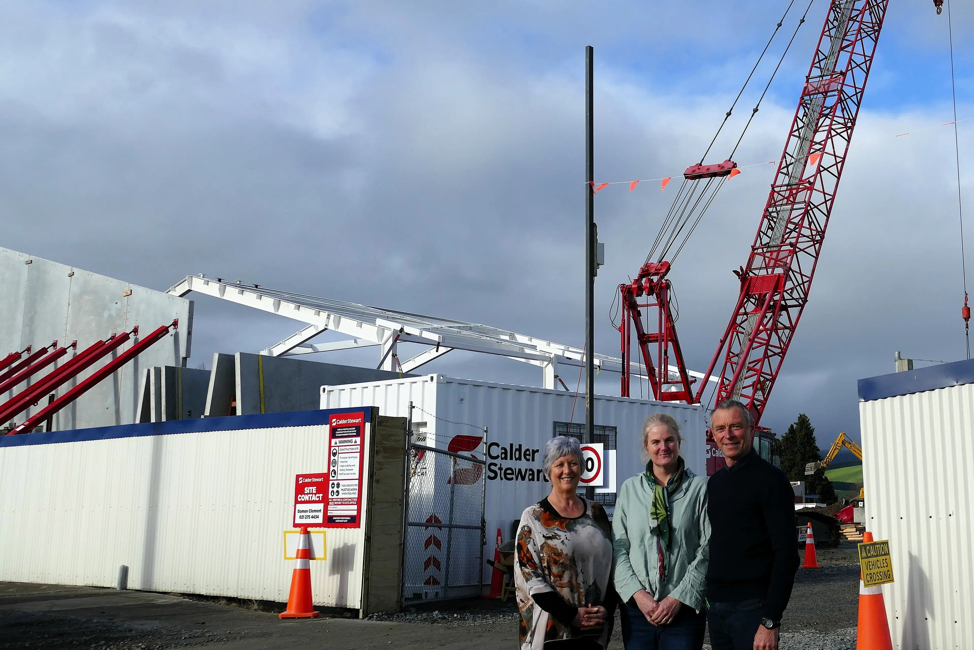 Bruce Community Facilities Trust members (from left) Dale Wyber, Kim Schiller and fundraising chairman Stephen Woodhead celebrate the trust receiving $1.7 million in grants yesterday, as work continues at the site of the new Elsie Stewart Community Library and Pool in Milton. Photo: Richard Davison