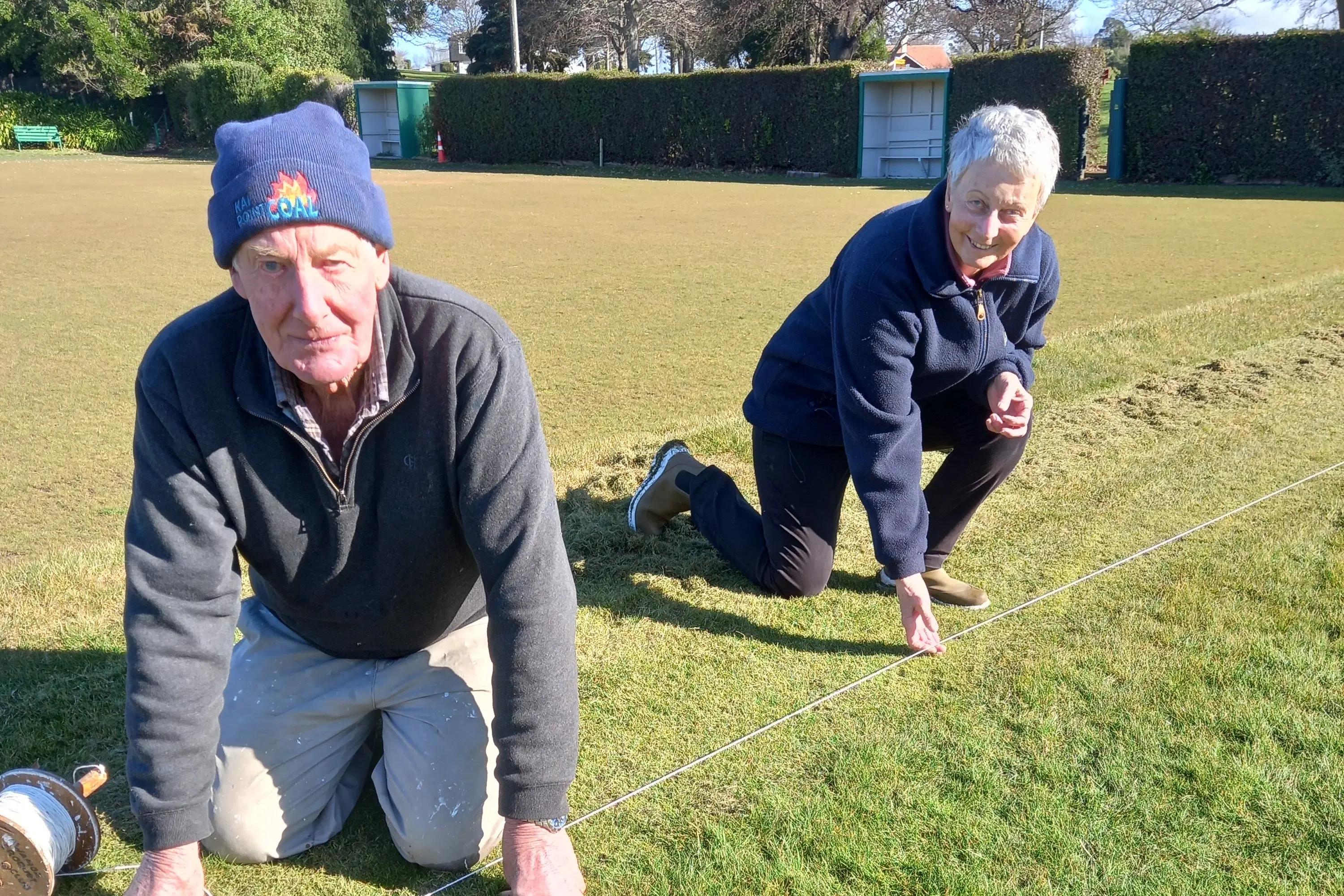 Graham Ormandy and Kat Scrivener mark out the lawns at the Awamoa Gardens Croquet Club. Photo: Supplied