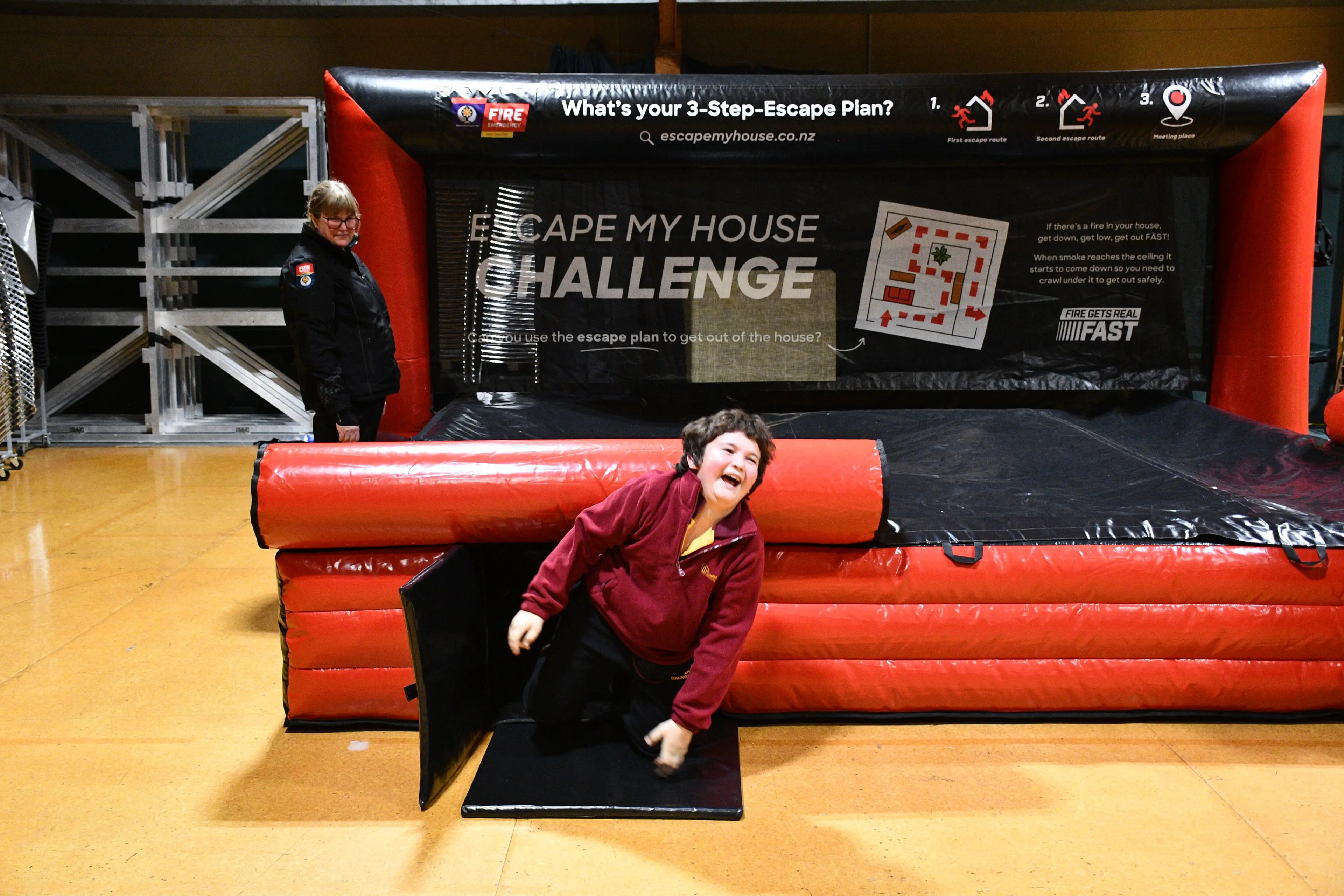 Celebrating making it through the Fenz dark maze is Larome Edwards, 10, of Mataura School, with the support of Fenz Te Kei community risk manager Delia Riley, at the Clued up Kids event on Tuesday. Photo: Gemma Sinclair