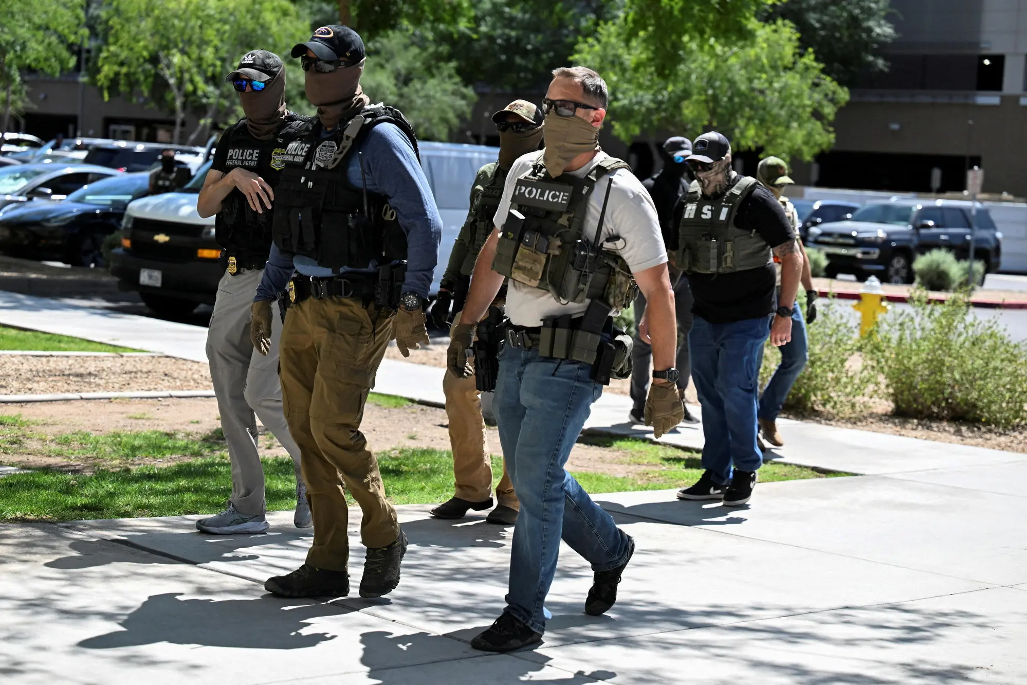 Masked law enforcement officers including ICE agents. Photo: Reuters