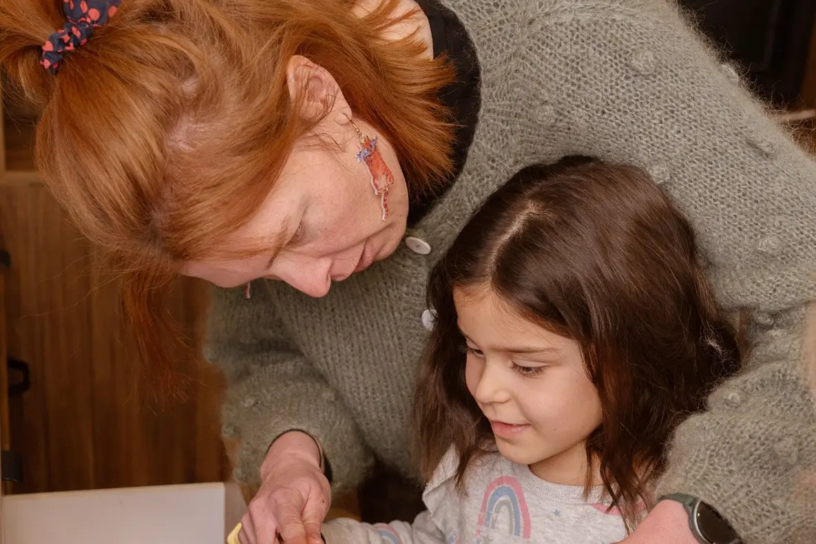 Lee Stream School principal Kate Martin helps pupil Ruby Usherwood, 6, with her knitting in the \\'\\'woolshed\", a shipping container filled with wool. Photo: Oh Peony Studio