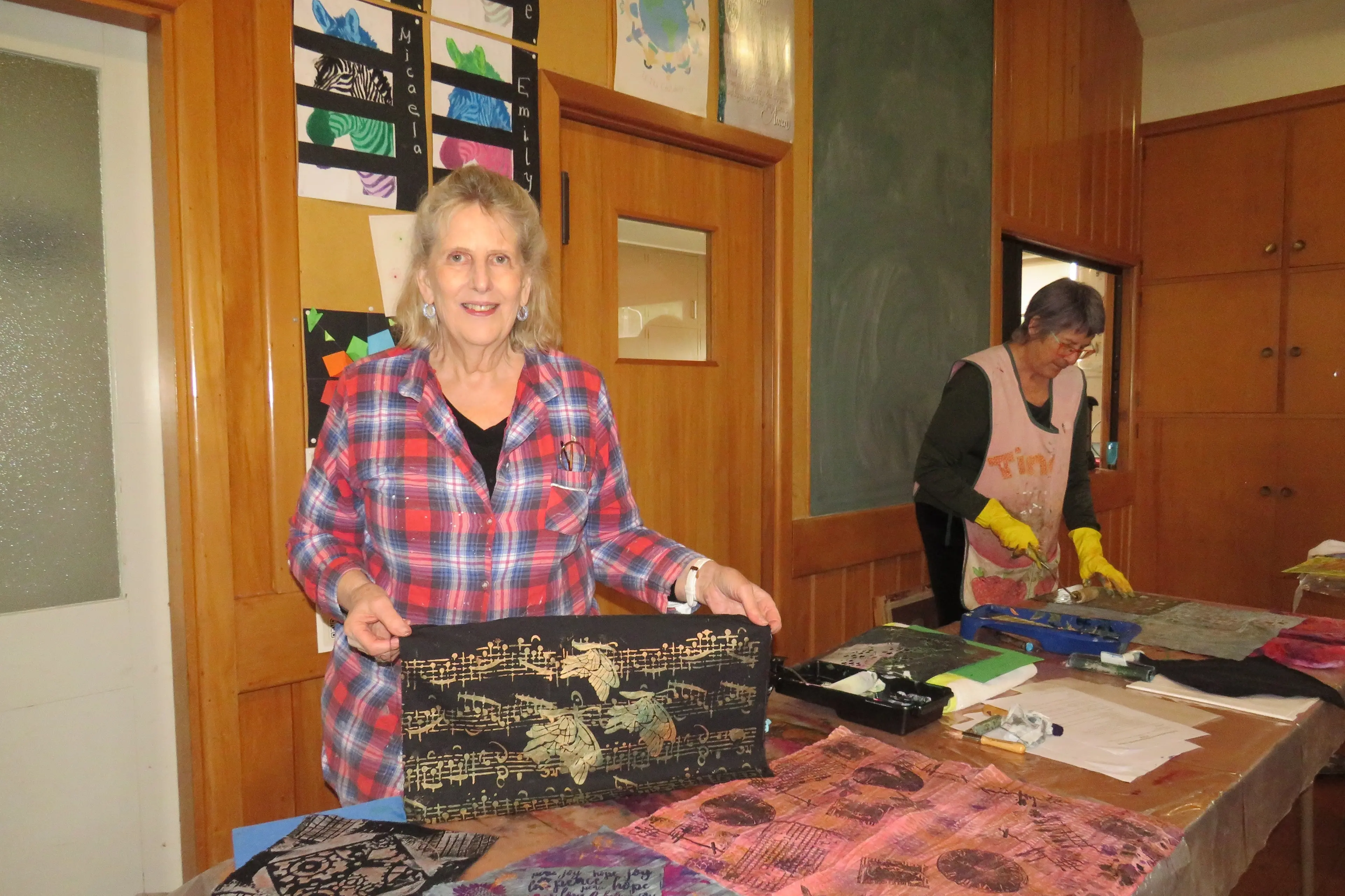 Trying out fabric printing Heather Salton (left) with some of the pieces she created as Tina Lucas works on a her printing. Photo: Dellwyn Moylan