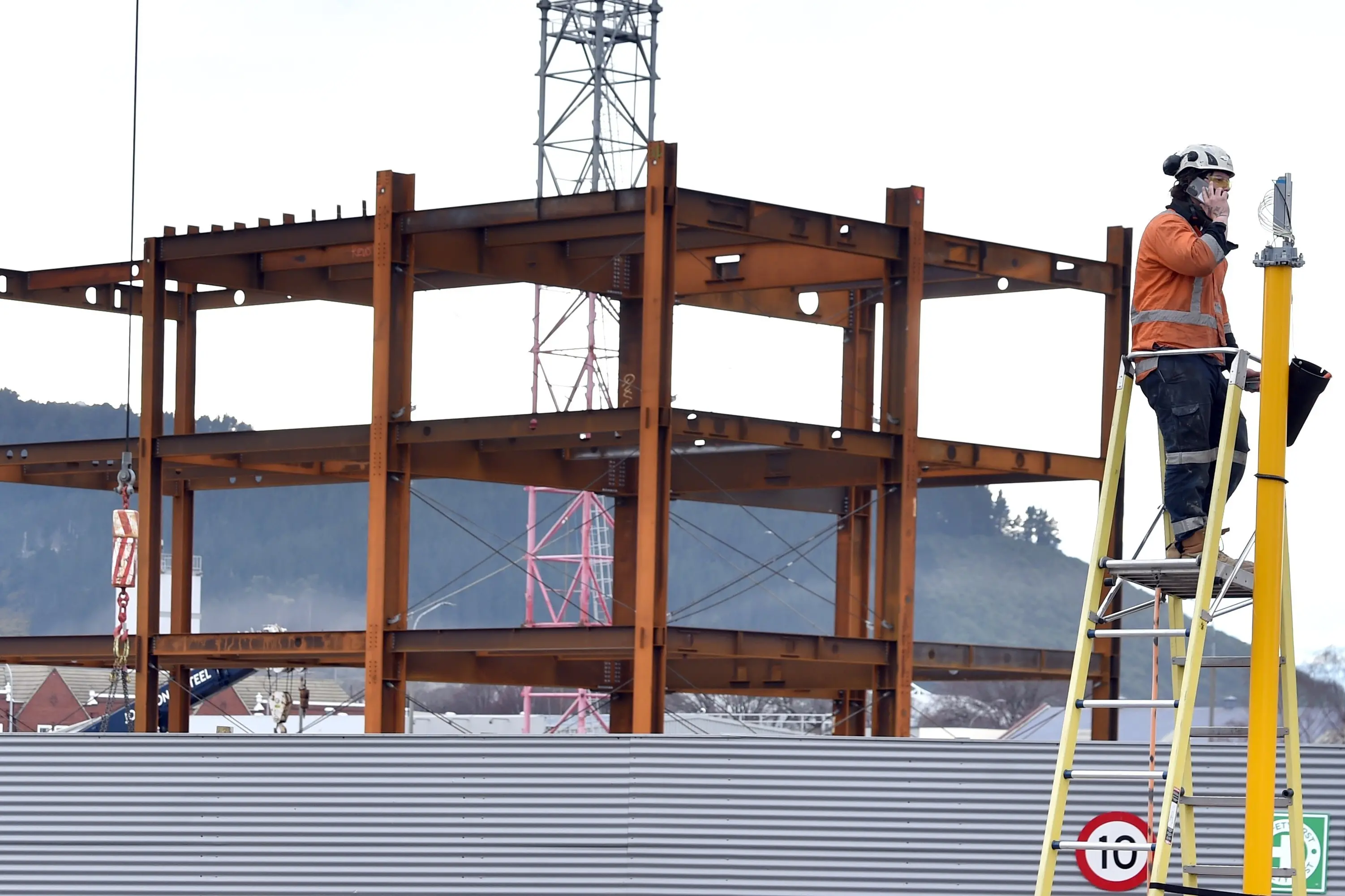 A contractor works on a traffic light in Cumberland St outside the new Dunedin hospital on Thursday. Photo: Peter McIntosh