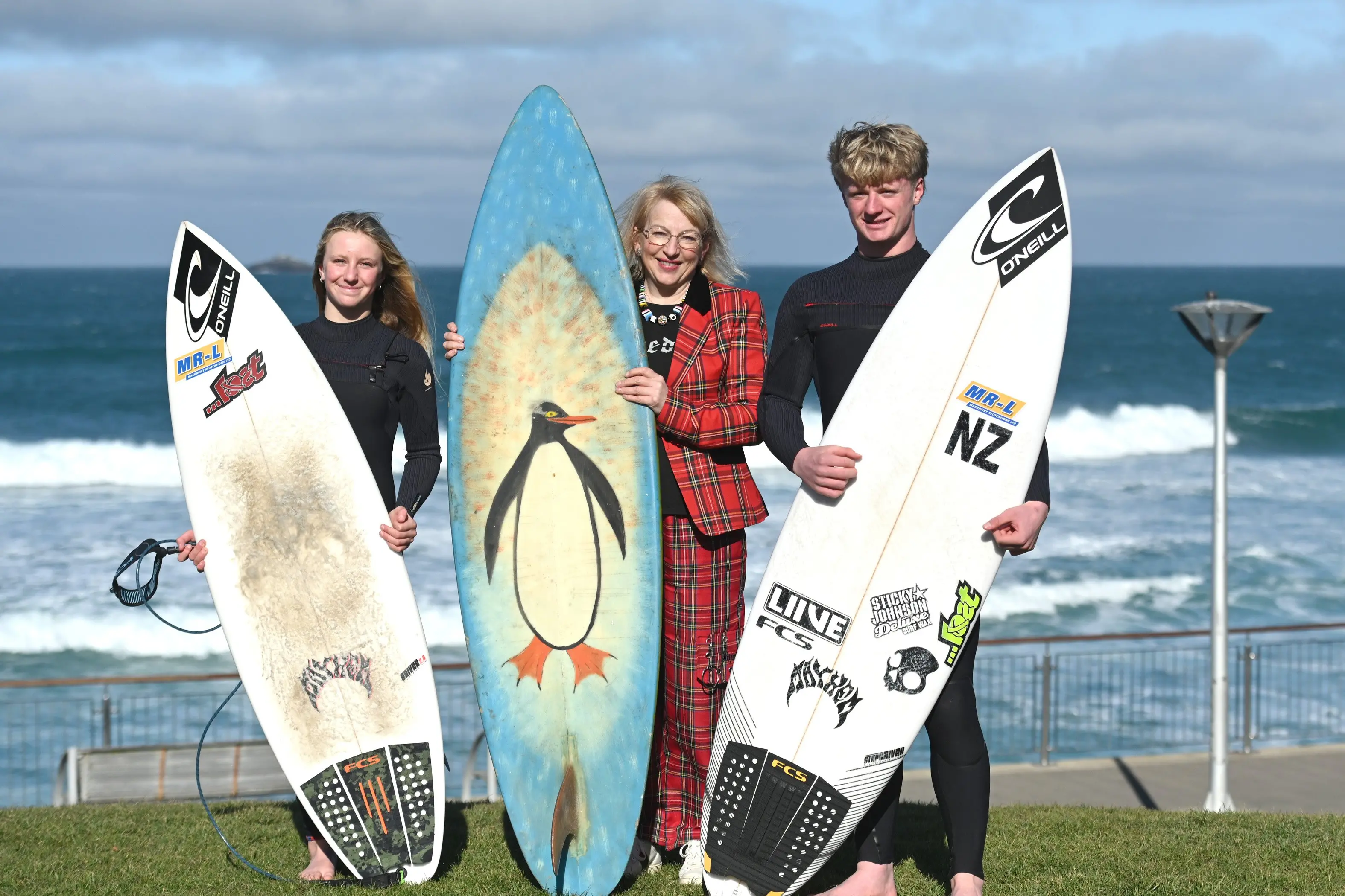 Dunedin Mayor Sophie Barker with South Coast Boardriders members siblings Zara, 13,  and Alexis Owen, 18, at St Clair Beach. Photo: Linda Robertson