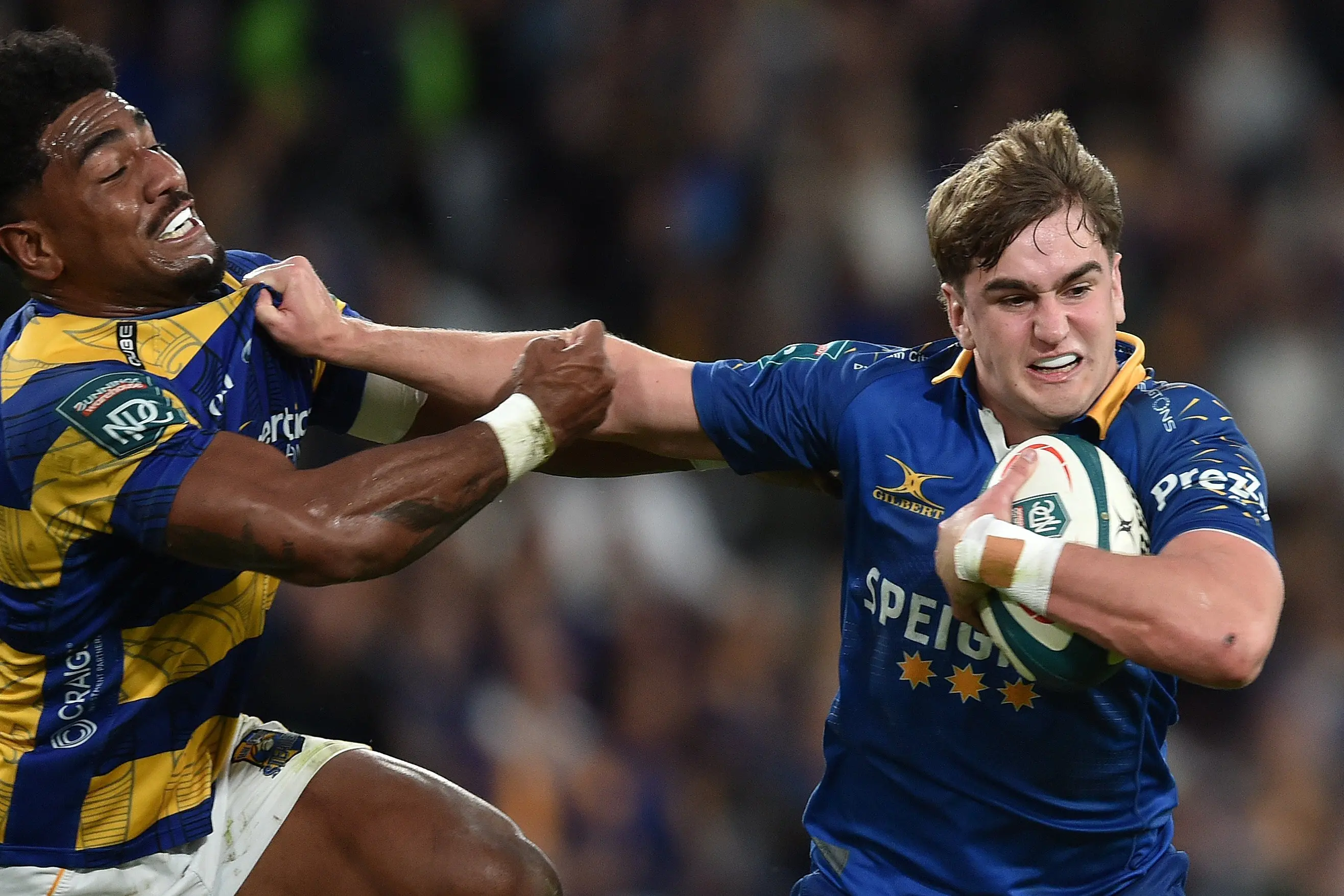 Otago winger Jae Broomfield holds off Bay of Plenty flanker Veveni Lasaqa during the NPC semifinal at Forsyth Barr Stadium. PHOTO: GREGOR RICHARDSON