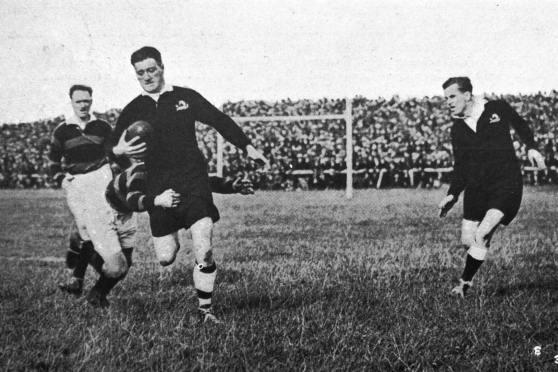 Craddock \"CC\" Dufty is tackled in first match of the New Zealand rugby league team\\'s tour of England, in which they beat Dewsbury 13-9. Photo: <i>Otago Witness</i>, issue 3791, November 9, 1926, page 42