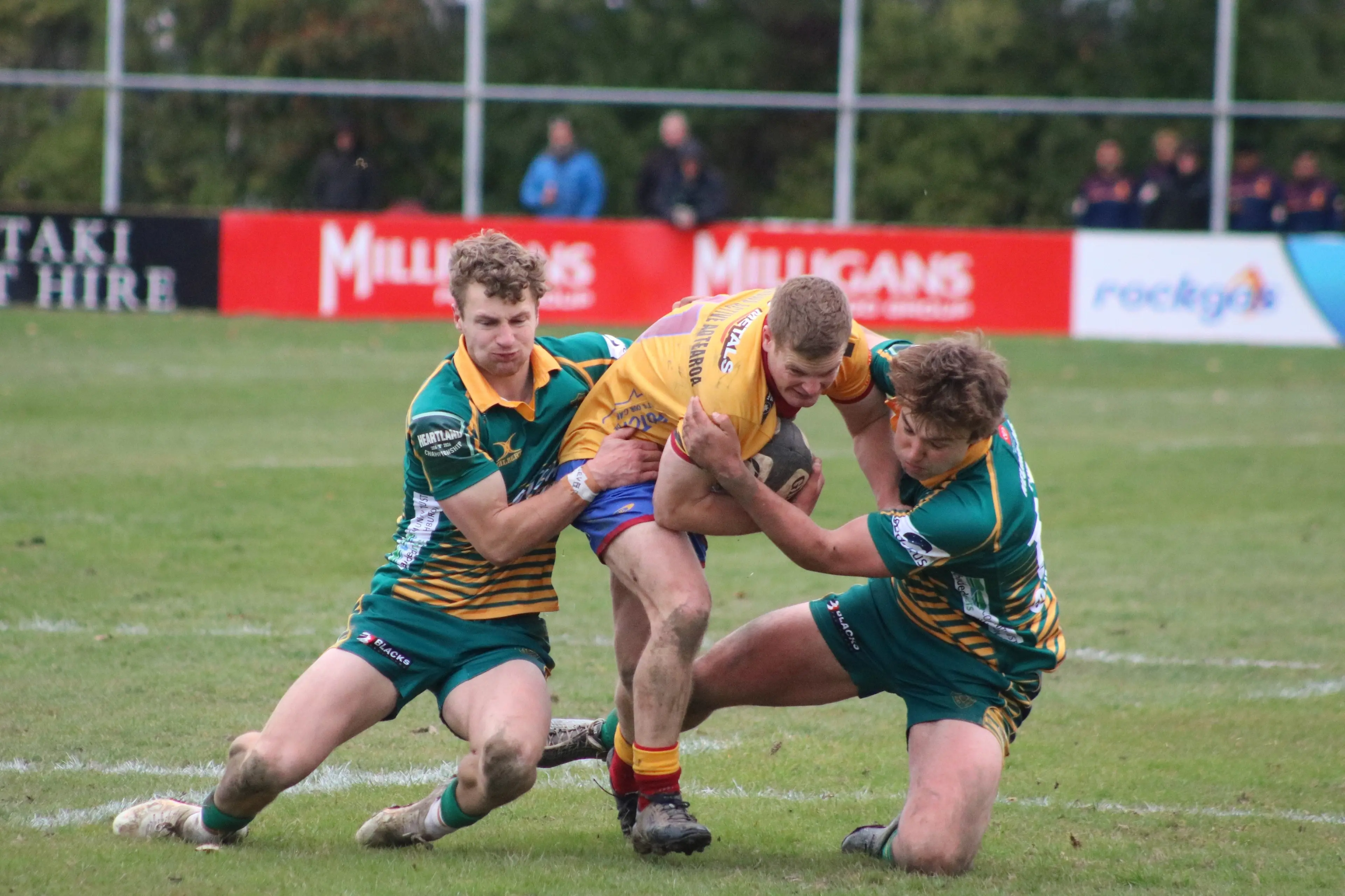 North Otago winger Ben McCarthy tries to break through the tackle of Mid Canterbury defenders Sam Pearce (left) and Hugh Cameron during the Heartland Championship game in Oamaru on Saturday. Photo: Kayla Hodge