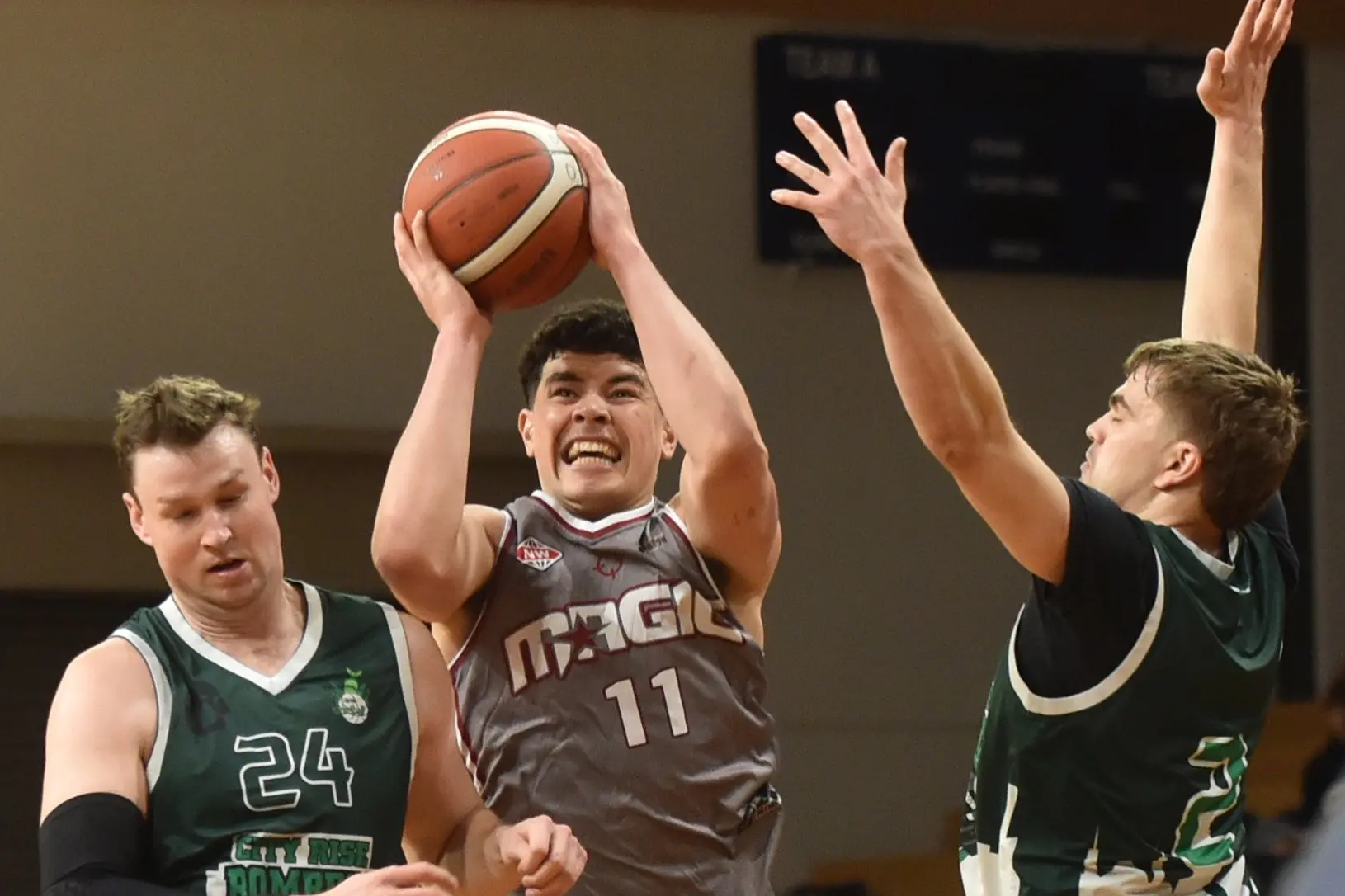 Ieremia Morris (Mid City Magic) fights hard to get off a shot between City Rise Bombers defenders Matt Brien (left) and Tom Cowie during the Dunedin A grade men\\'s club basketball final at the Edgar Centre on Saturday. Photo: Gregor Richardson
