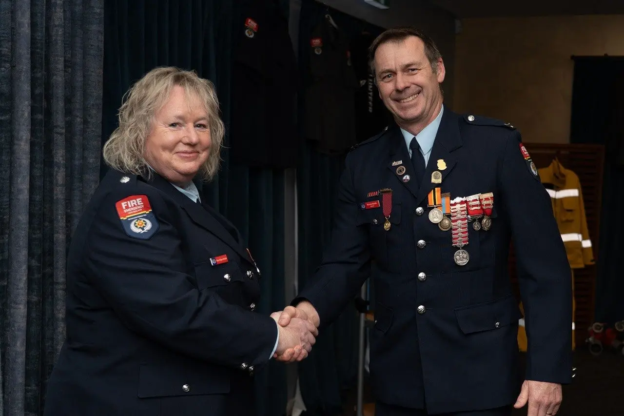 Willowby Volunteer FireBrigade fire chief Debs Stilgoe-Brooke is presented with her 25 year Gold Star from UFBA representative and Ashburton firefighter Warren Maslin presented she became first woman originating from a Mid and South Canterbury rural fire service receive the honour. Photo: Supplied