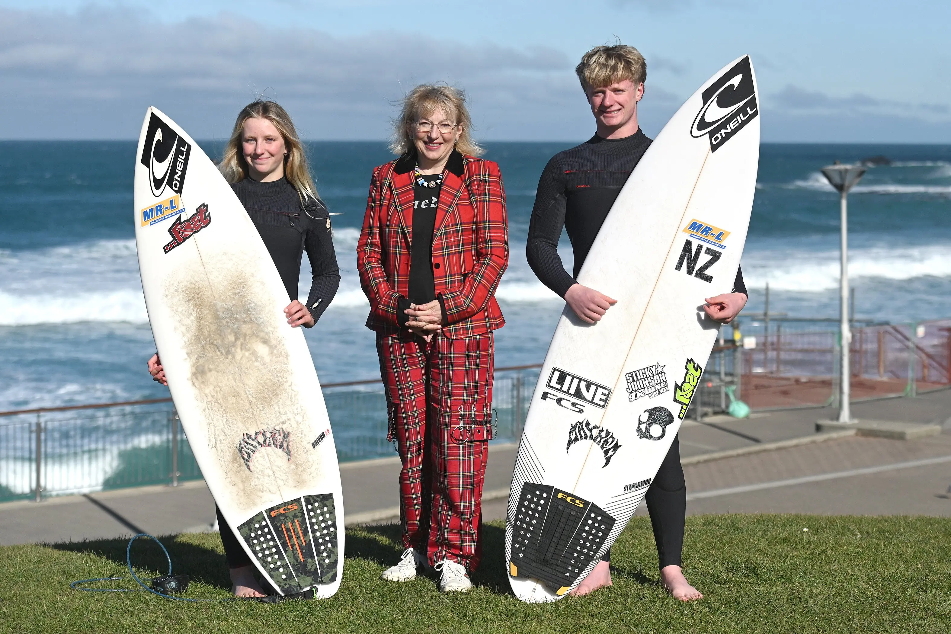 Dunedin mayor Sophie Barker with South Coast Board riders, siblings Zara Owen, 13, (left) and Alexis Owen, 18, at St Clair, to promote an upcoming surf event. Photo: Linda Robertson