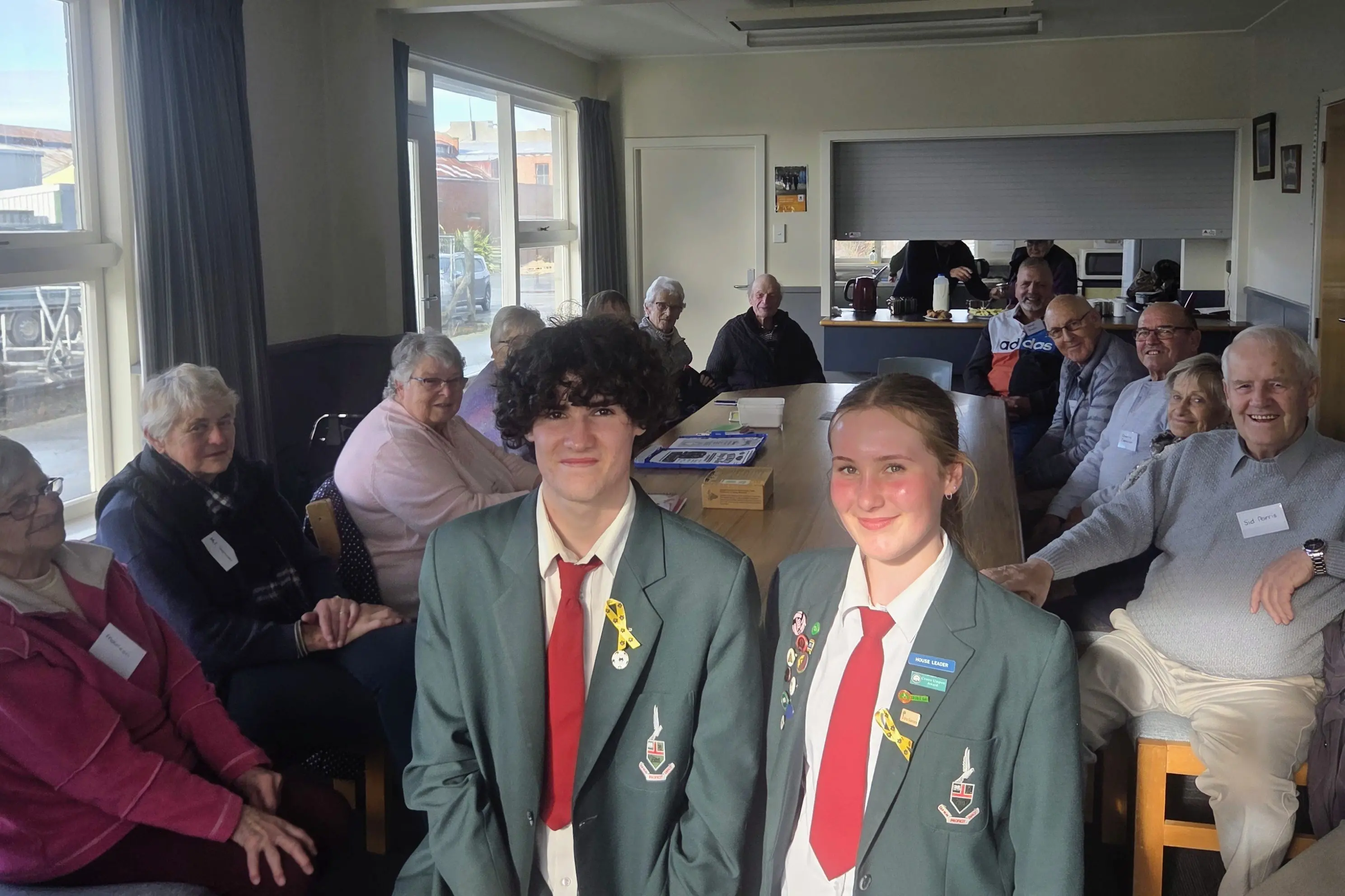 Waimate High School Year 12 students\\u00A0Chev James and Sophie Hargreaves\\u00A0take a moment to reflect with the local Cancer Companions while organising next week\\'s Daffodil Drive. Photo: Supplied