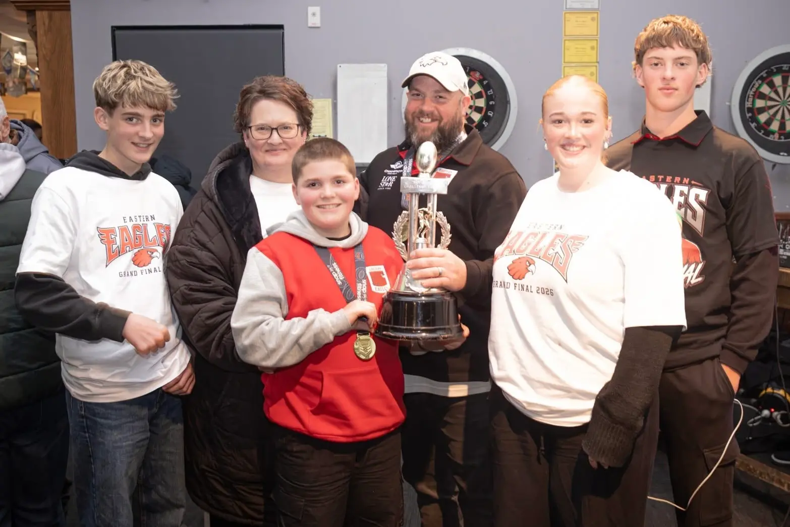 Jarrod Race and his family with the Pat Smith Trophy after Eastern\\'s title win. From left: Aiden, Cherie, Mason, Jarrod, Kayla, and Lucas. Photo: Supplied