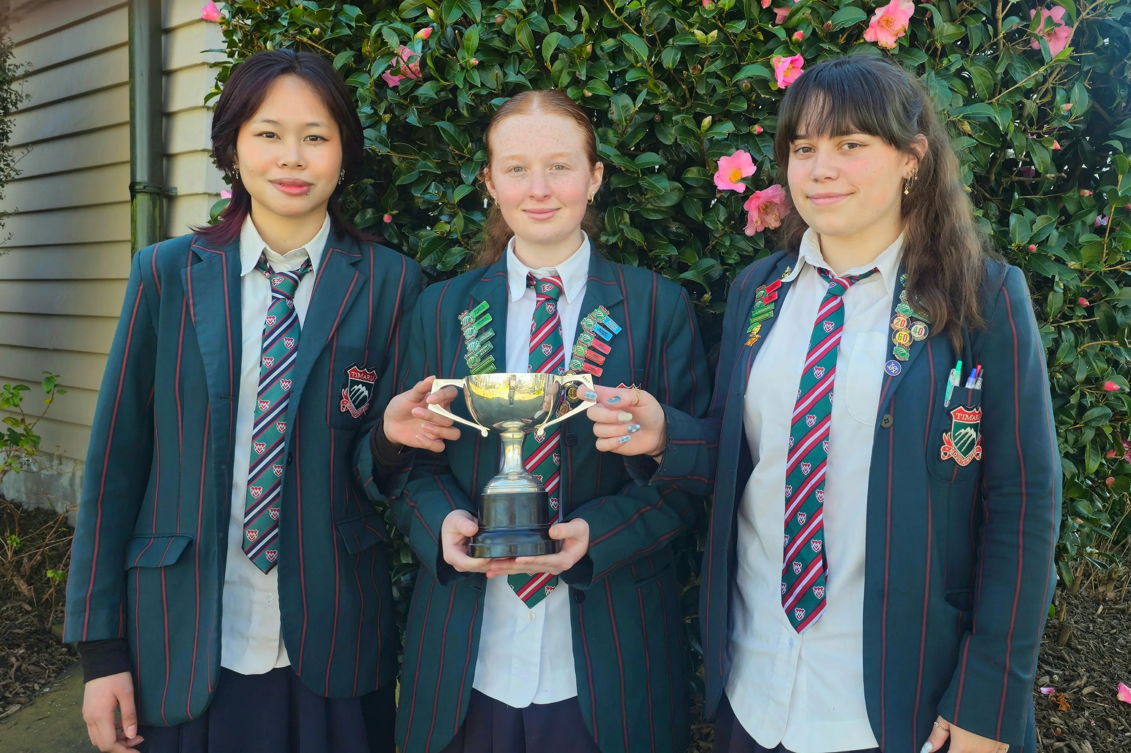 Showing off the Aoraki Secondary Schools Girls A Grade Championship trophy are Mountainview High School Senior Girls\\' badminton team members (from left) Lois Agbas, 16, Zoe Curtis, 17, and Chloe Smith, 17. Photo: Connor Haley