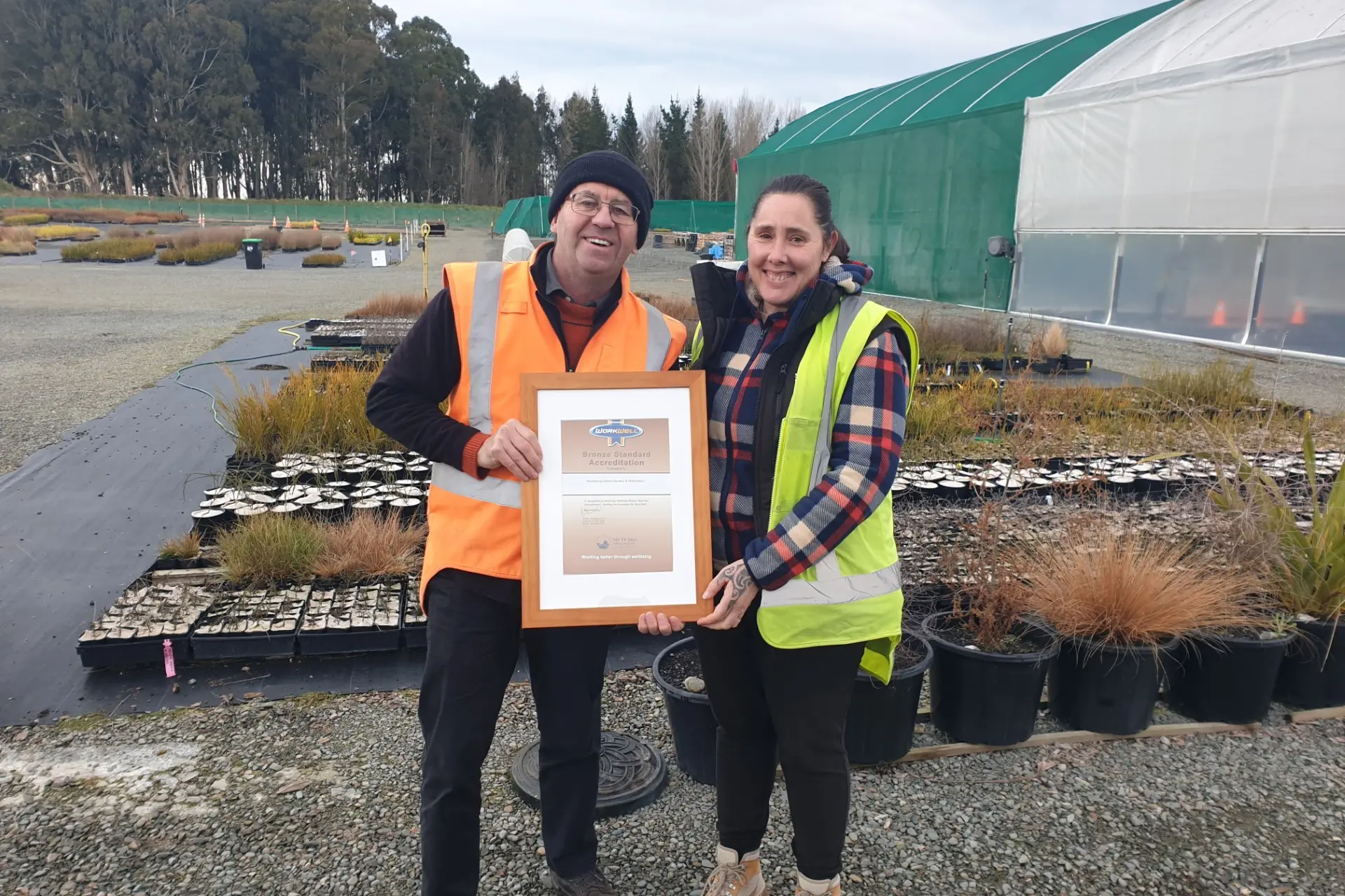 Arowhenua Native Nursery and Restoration health and safety manager Tony Doy (left) and general manager Felicity McMillan show off their WorkWell bronze accreditation. Photo: Supplied