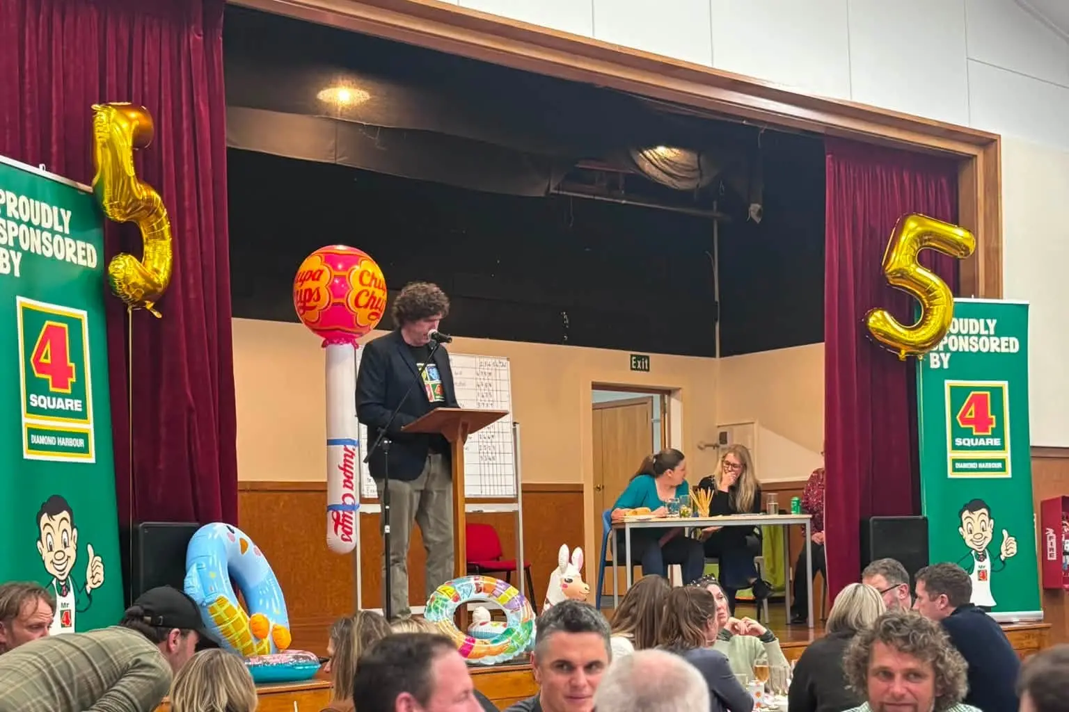 Diamond Harbour Four Square co-owner James Grant on stage at the fundraiser. Photo: Supplied