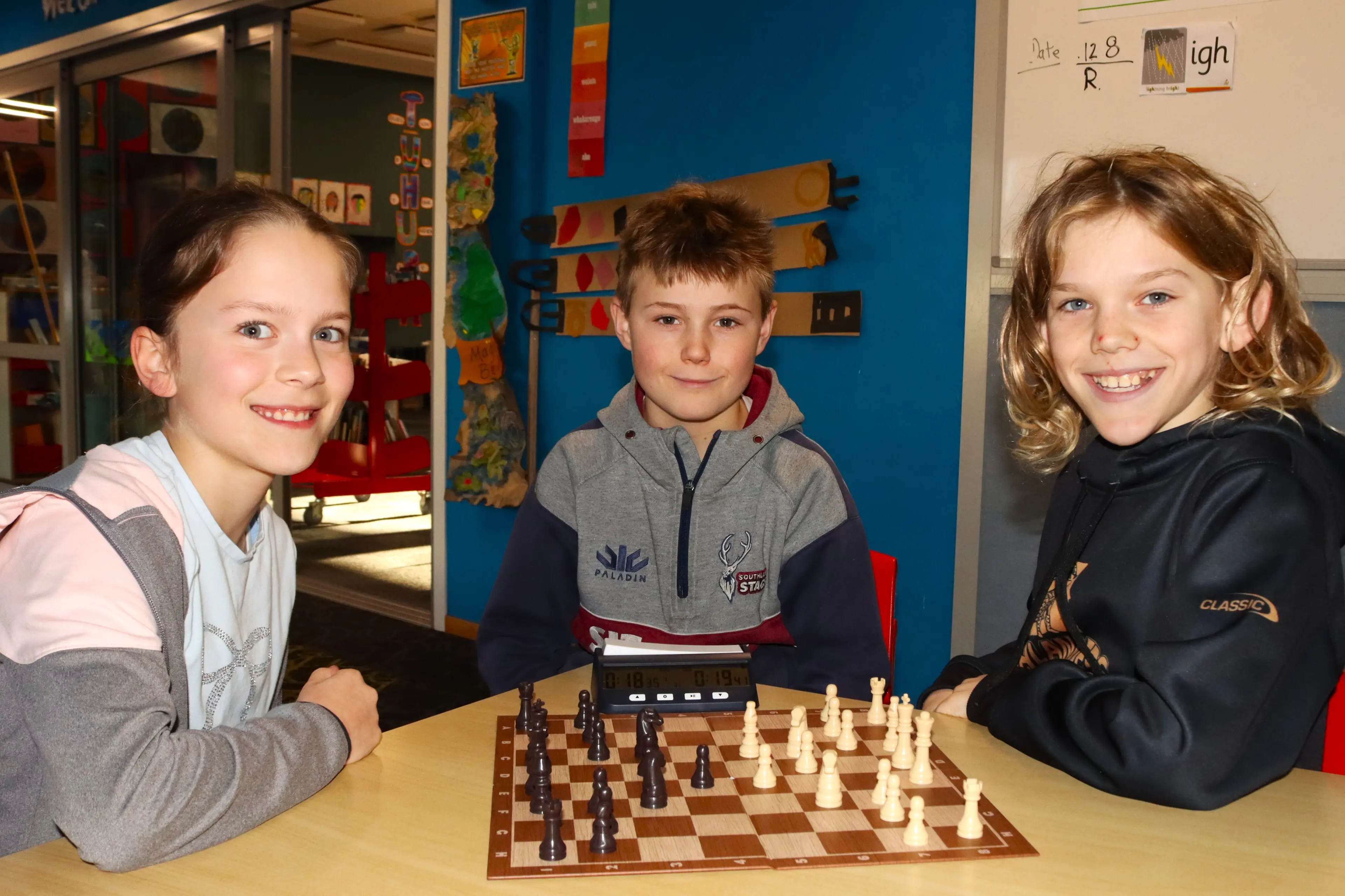 Looking forward to showcasing their chess skills are Macandrew Bay School pupils (from left) Anne Bertolli, 11, Jack McKee and Sean van Voornveld, both 10. Photo: Sam Henderson.