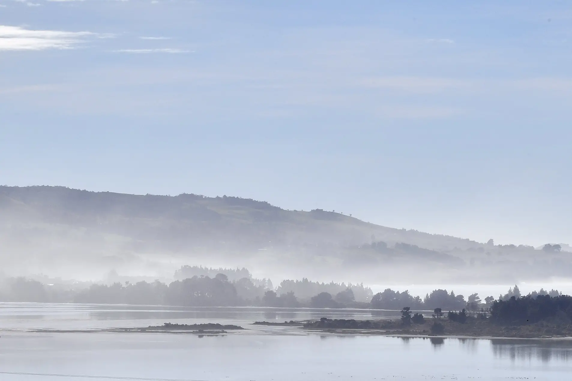 Sea mist hangs over Warrington and at low level along the headlands heading north of Blueskin Bay last month. Photo: Stephen Jaquiery
