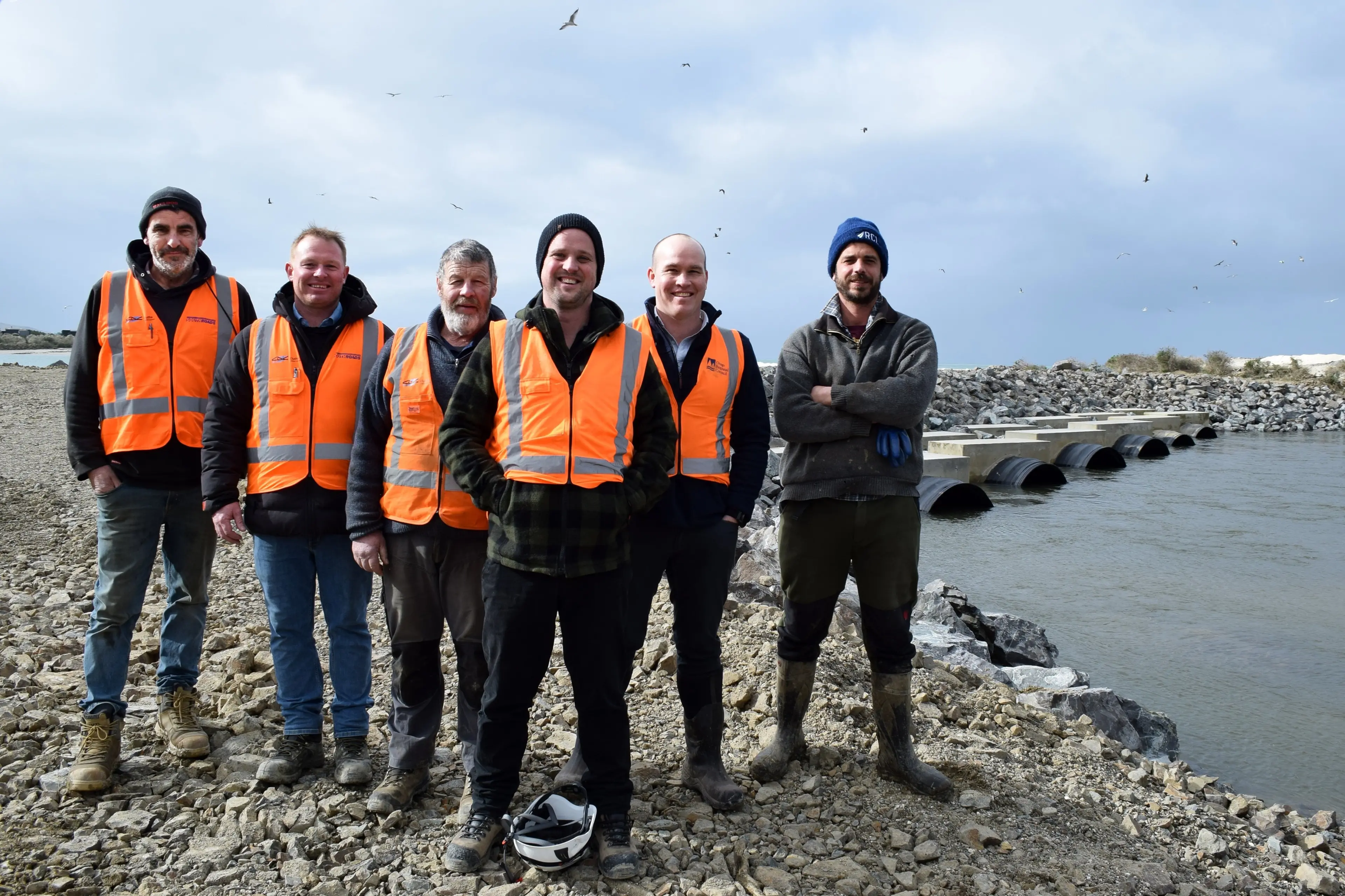 At a celebration\\u00A0of the upcoming completion of a nearly $3 million upgrade on the coastal Puerua River training wall at the mouth of the Clutha River in South Otago are\\u00A0(from left) SouthRoads excavator operator Craig Soper, contract manager James Cook and foreman Beau Jenkins, JVP Civil Management engineer Josh von Pein,\\u00A0Otago Regional Council science and resilience general manager Tom Dyer and dairy farmer\\u00A0Robbie Byars. Photo: Shawn McAvinue
