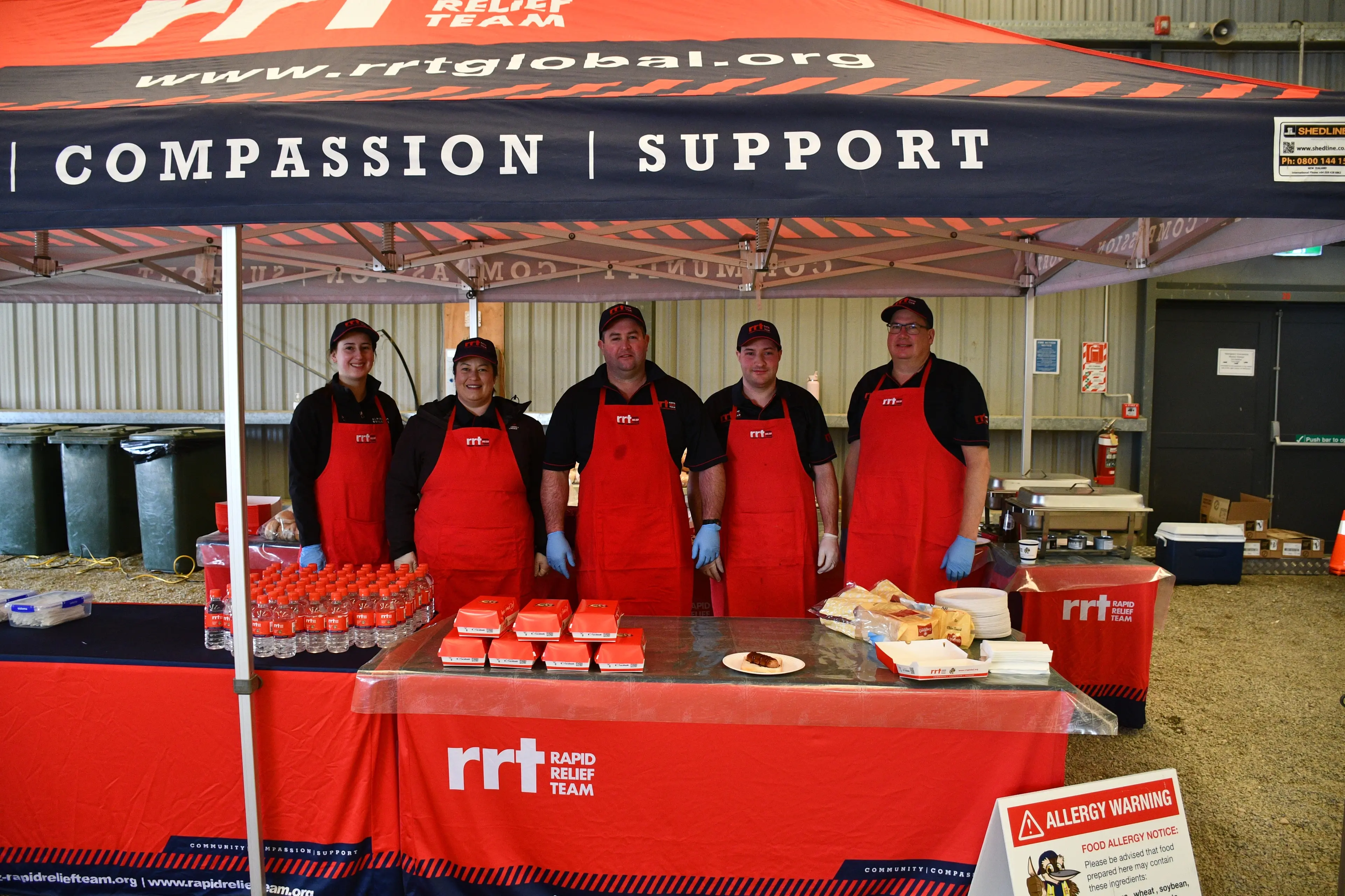 One of the many events Gore Rapid Relief Team members (from left) Shani Brewerton, Ingrid Stewart, Oscar McKissock, Perry Stewart and Owen Brewerton support by serving burgers is the annual Hug a Rig event, in Waimimu, near Gore, on August 8. Photo: Gemma Sinclair