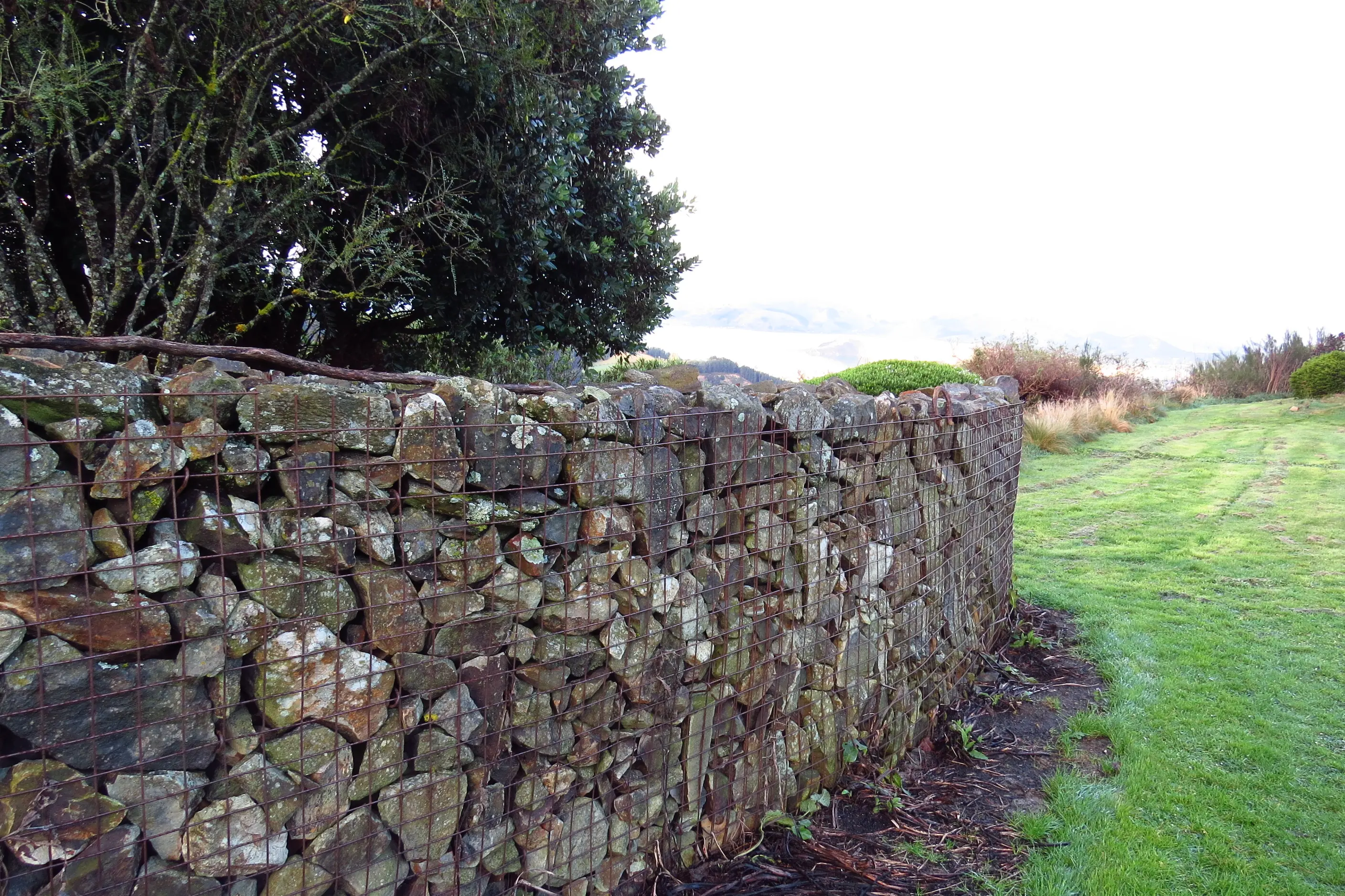 A gabion basket wall built by Mick Abbott and his partner: stones are regularly added. Photo: Maureen Howard