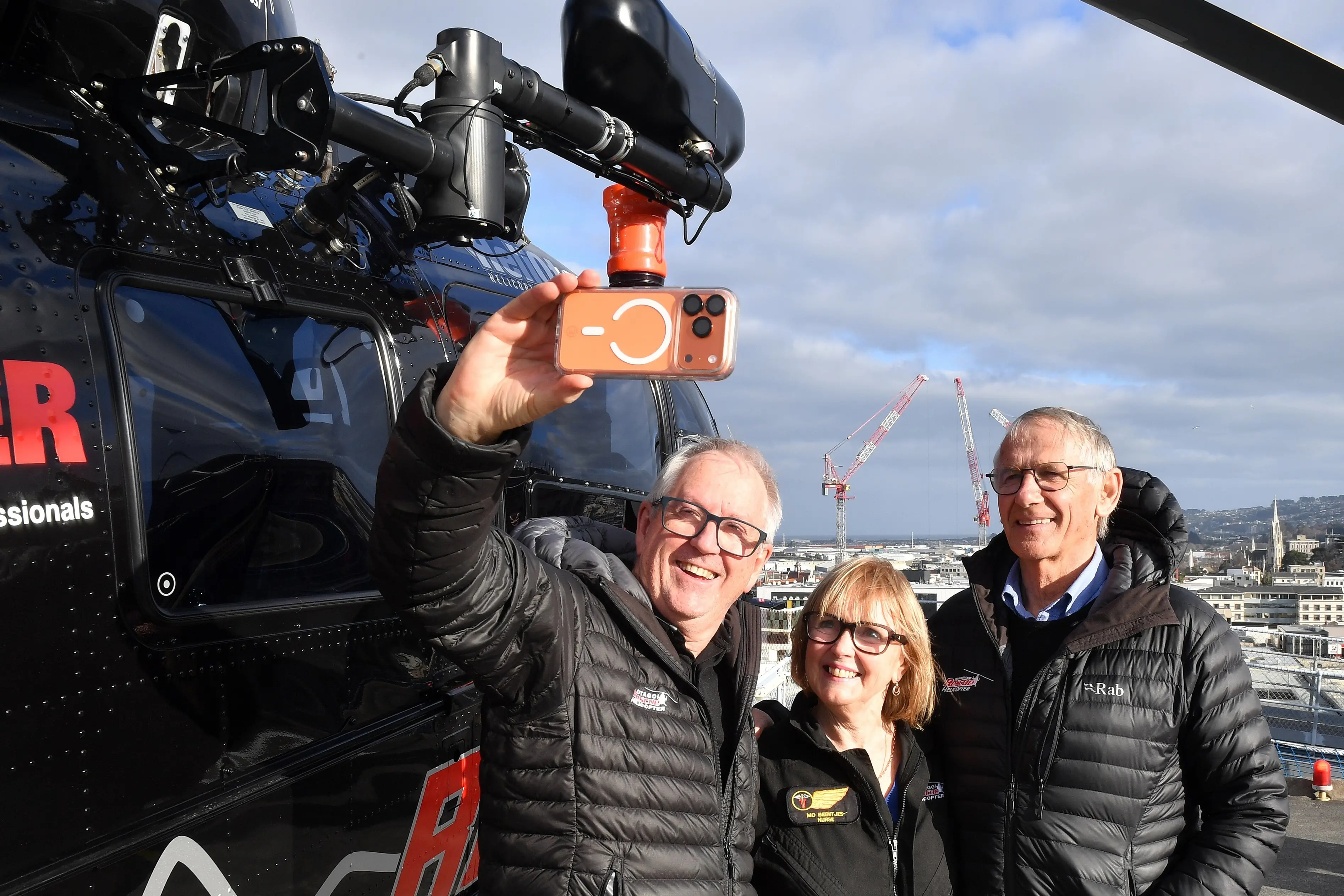 Flight nurse Mo Beentjes stands on the helipad at Dunedin Hospital for the last time with Doug Flett (left) and Graeme Gale, both of Helicopters Otago. Photo: Stephen Jaquiery