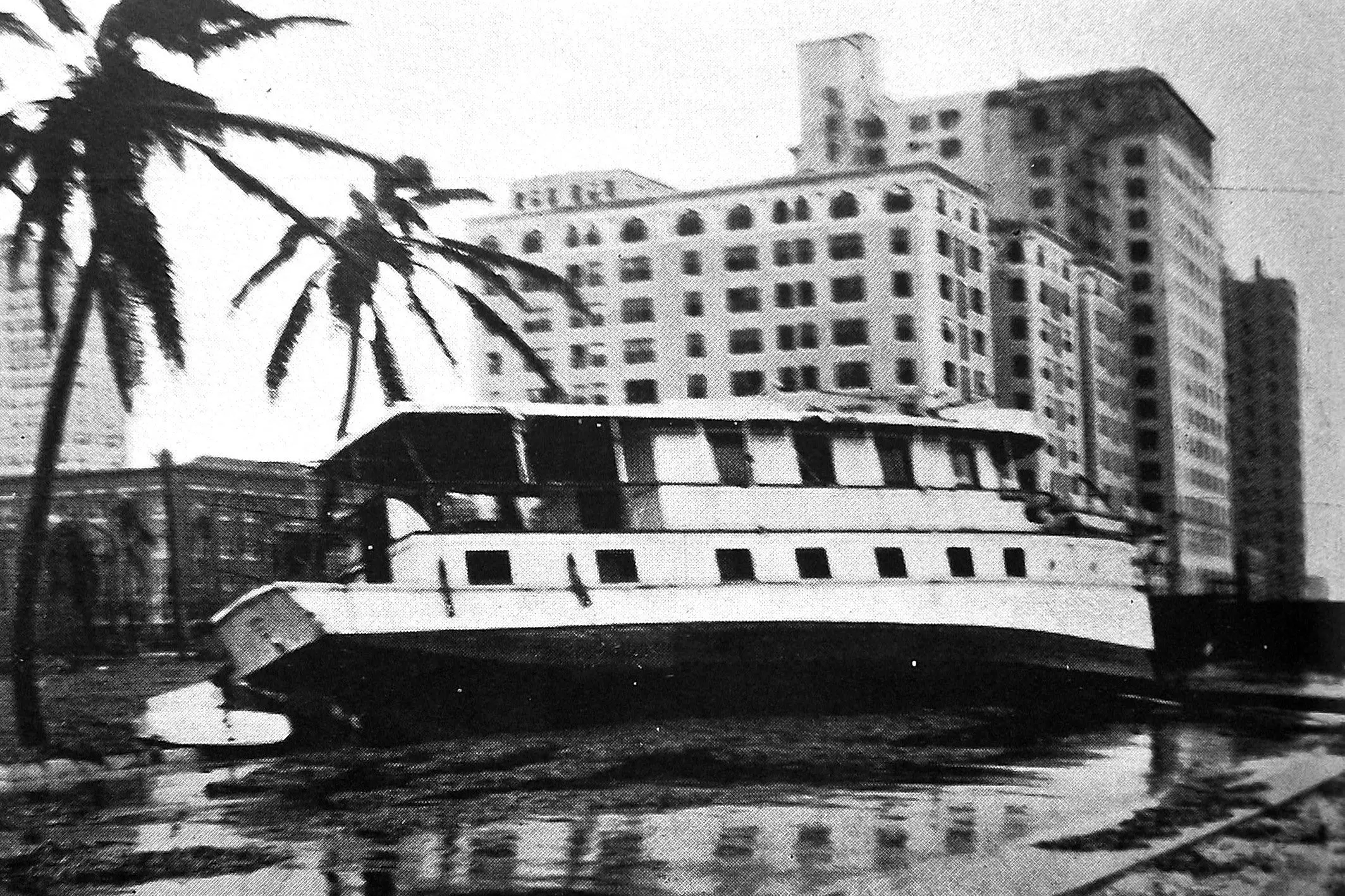 A large motor boat anchored in the harbour when the storm broke, which was caught in the flood and swept more than a quarter of mile into the heart of Miami, Florida by a hurricane, finally coming to rest in a vacant area near one of the hotels. Photo: <i>Otago Witness</i>, issue 3791, November 9, 1926, page 40