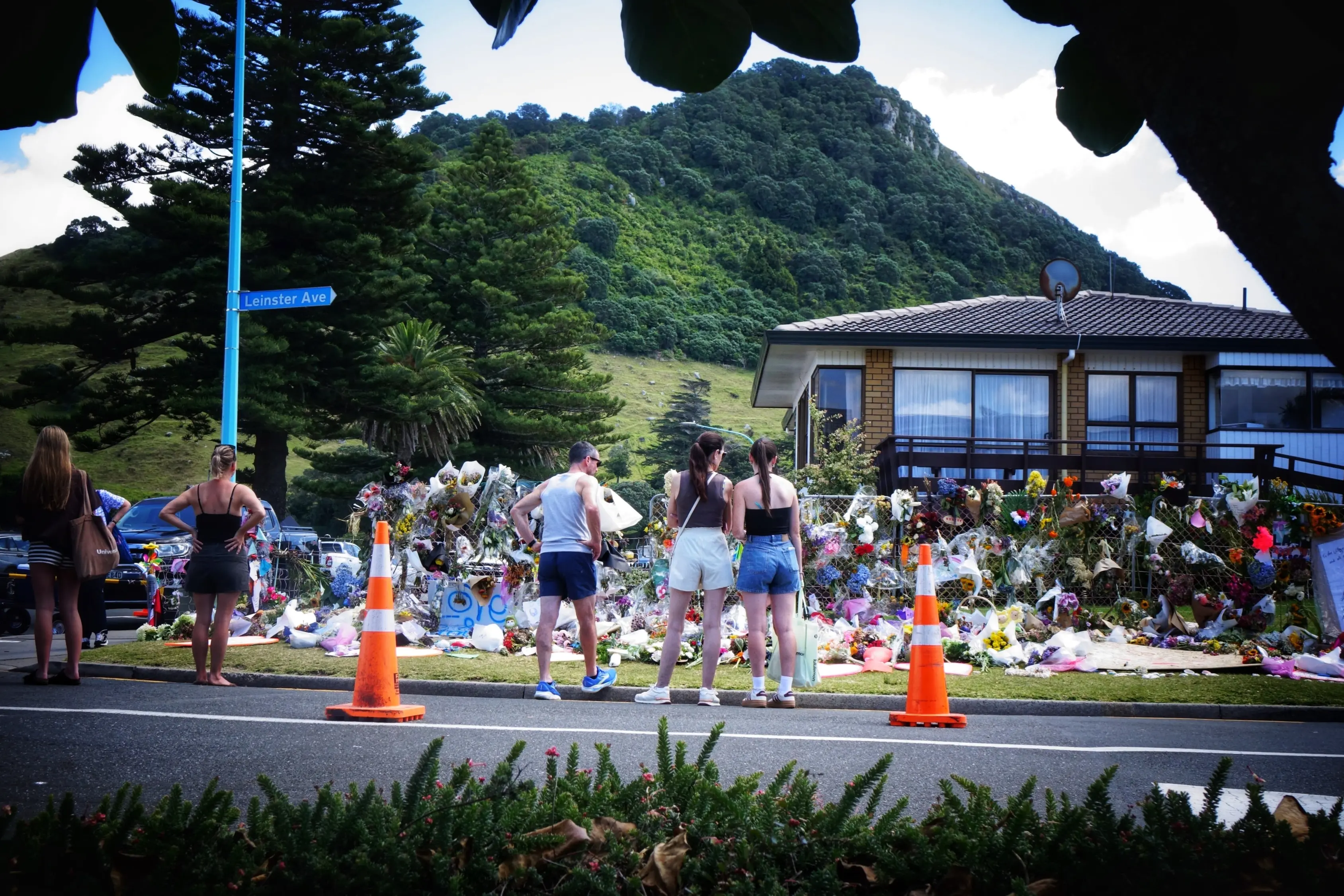 People reflect at a memorial site for the six people who died in a landslide in Mount Maunganui in this file photo. Photo: RNZ / Kim Baker Wilson