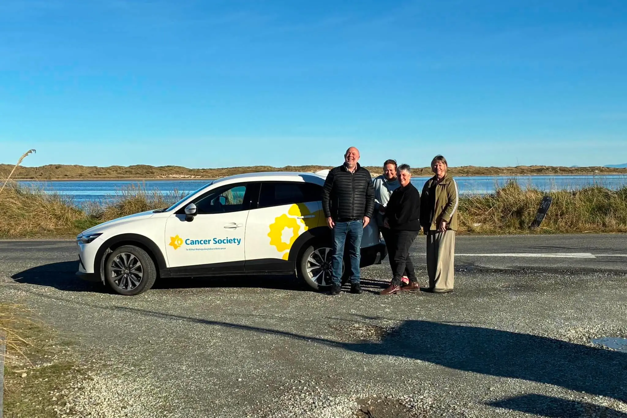 A fundraiser in Tokanui last year meant a Cancer Society car was purchased, it helps cancer navigator Aynsley Dermody (far right) reach and support people affected by cancer in Eastern Southland and West Otago, and she is with (from left) Cancer Society Southland community manager Gavin Booth, and Tokanui fundraiser organisers Callie Callahan and Suzie Matthews. Photo: Supplied
