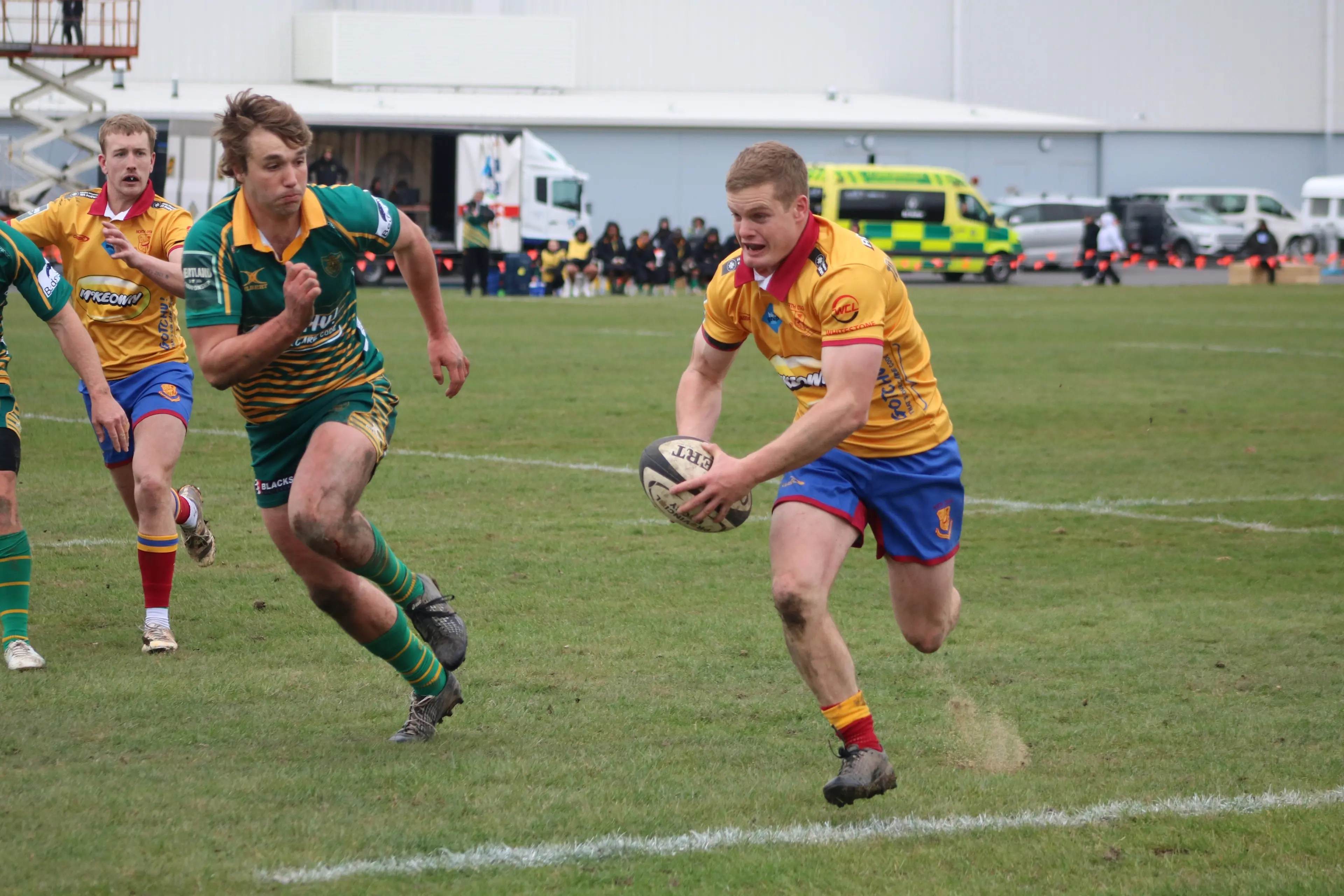 North Otago winger Ben McCarthy gets on the outside of Mid Canterbury full back Hugh Cameron to score during their Heartland Championship game in Oamaru. Photo: Kayla Hodge