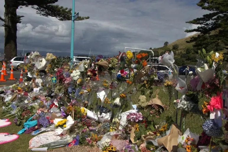 Bouquets and tributes at the Mount Maunganui landslide cordon. Photo: RNZ