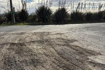 Running repairs . . . The impact of gravel trucks on the corner of South Eyre and Heywards roads. The road has since been repaired. Photo: Supplied by Juliet Edwards