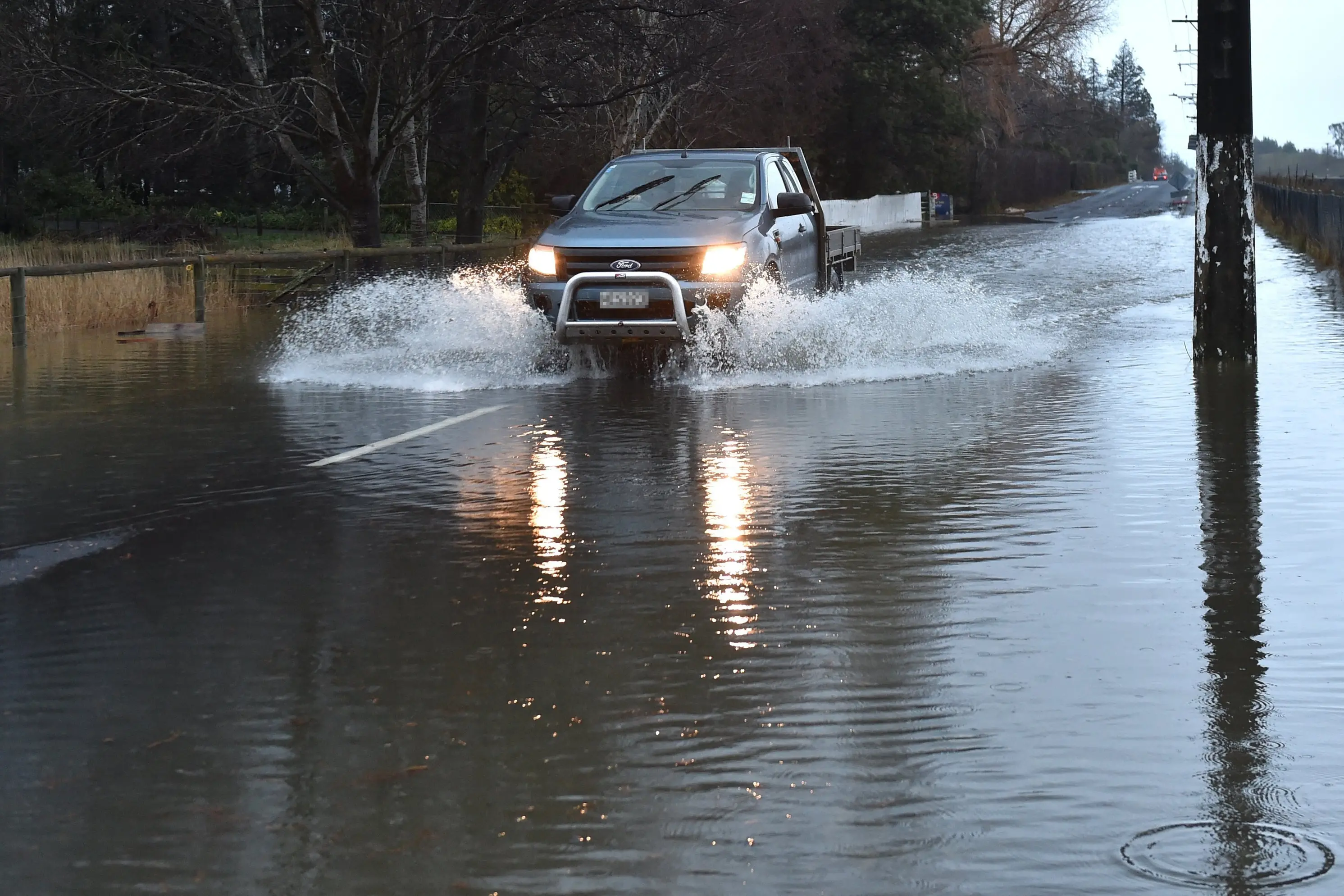 A ute travels through surface flooding in Gladstone Rd, Mosgiel, during heavy rain in June this year. Photo: Peter McIntosh