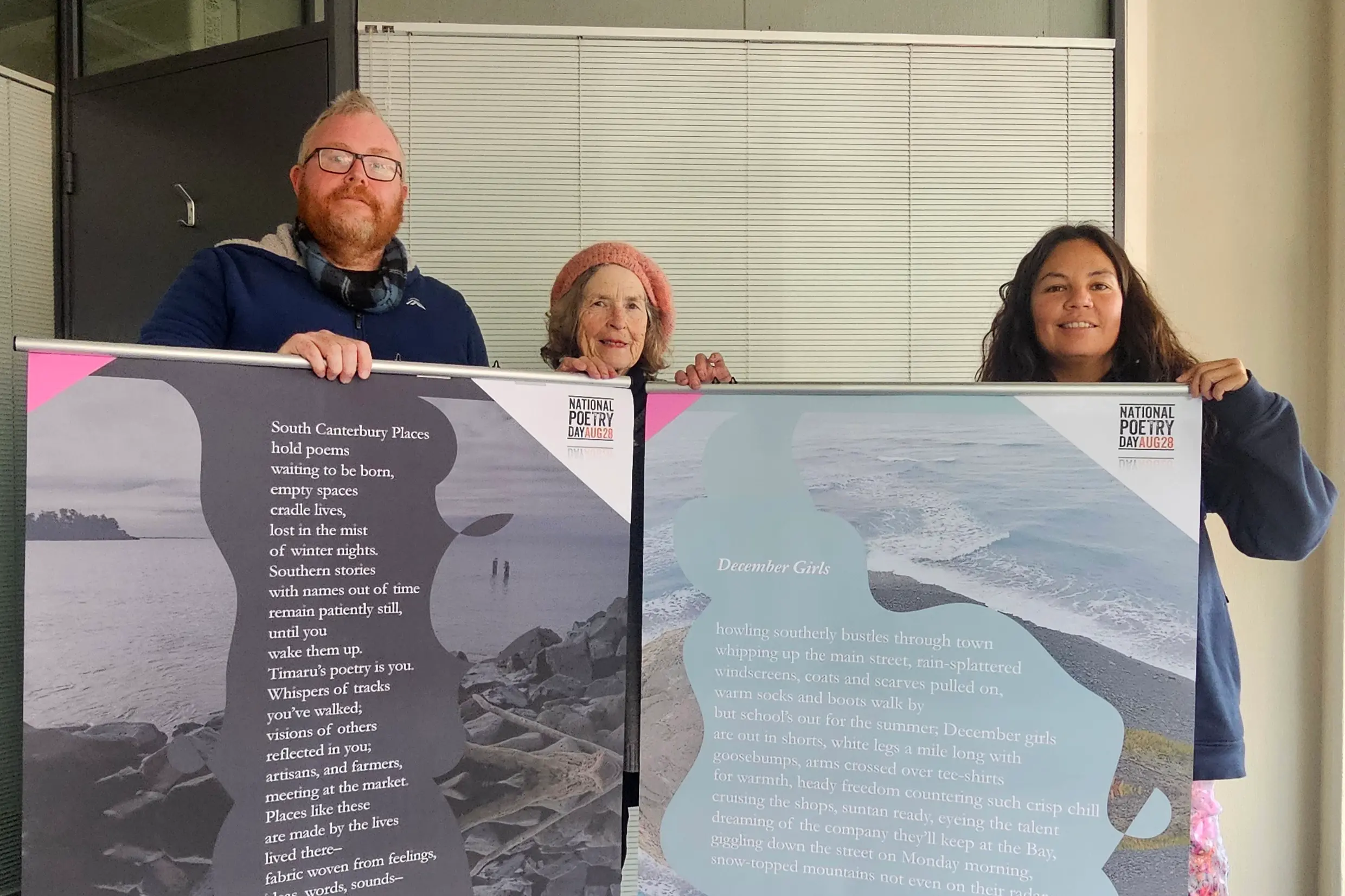 Getting ready to hang poetry posters in shop windows around Stafford St are (from left) South Canterbury Live Poets group members Dwayne Carter, Deirdre T. Lavery, and Ynes Guevara. Photo: Connor Haley