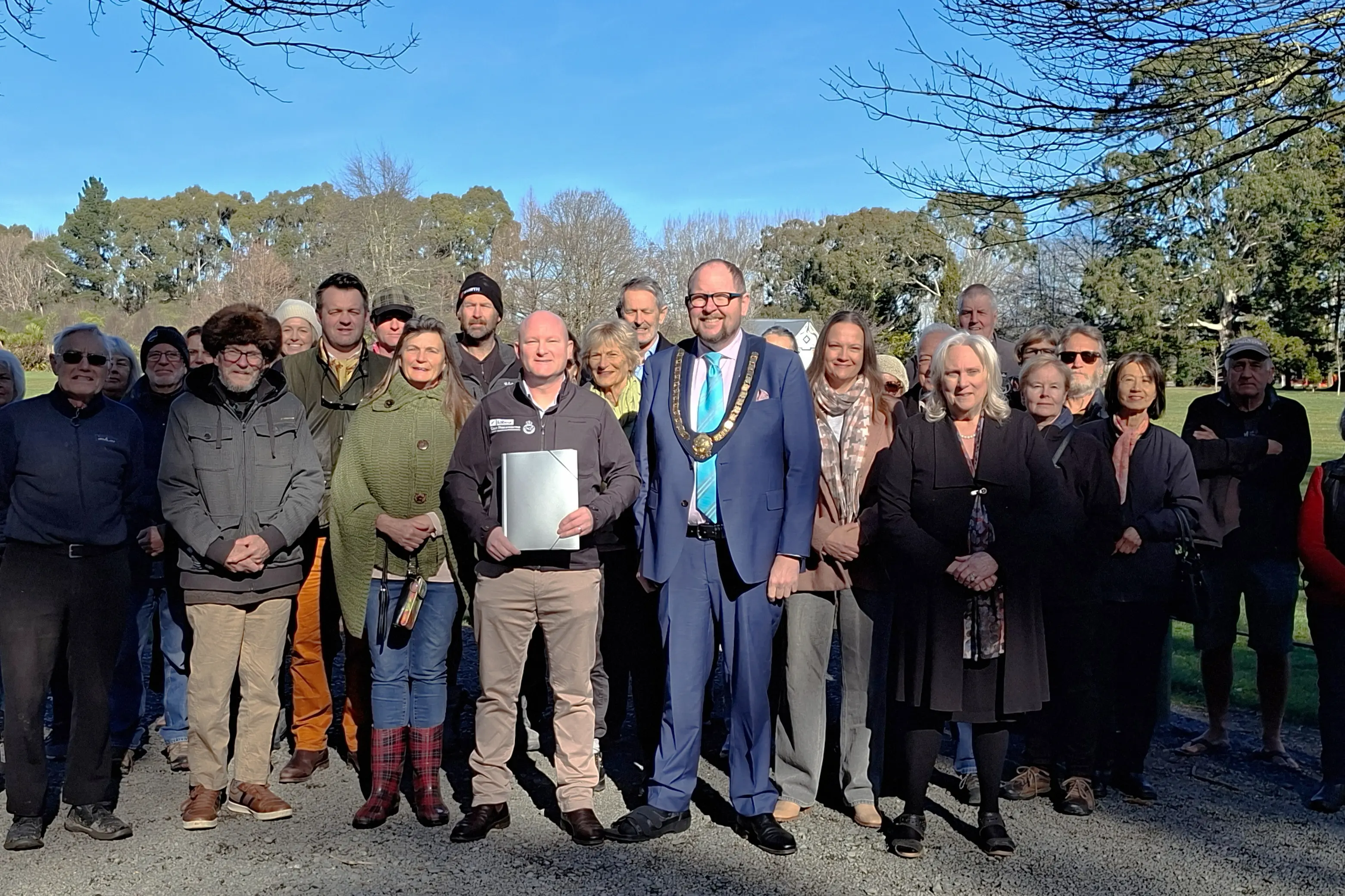 Together in opposition . . . Residents and community members, with Mayor Dan Gordon, MP Dan Rosewarne, and Oxford-\\u014Choka councillor Niki Mealings, at the petition handover at \\u014Choka Domain on Monday. Photo: Supplied