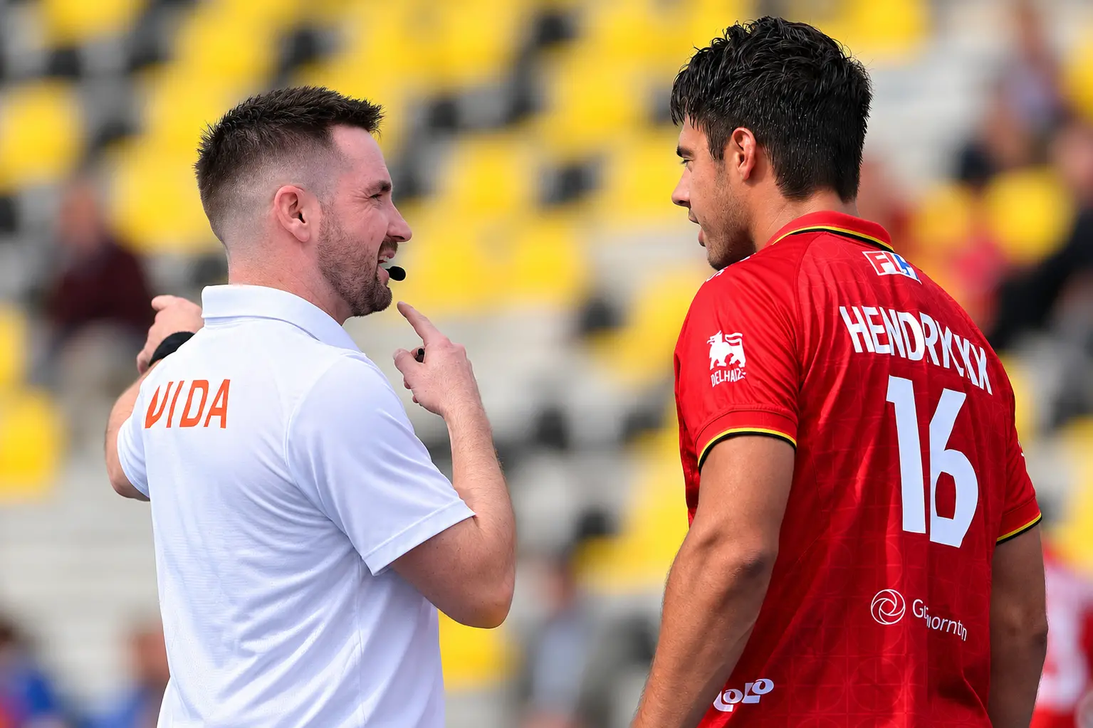 Ben Grant (left) delivers instructions to Belgium defender Alexander Hendrickx. Photo: Supplied