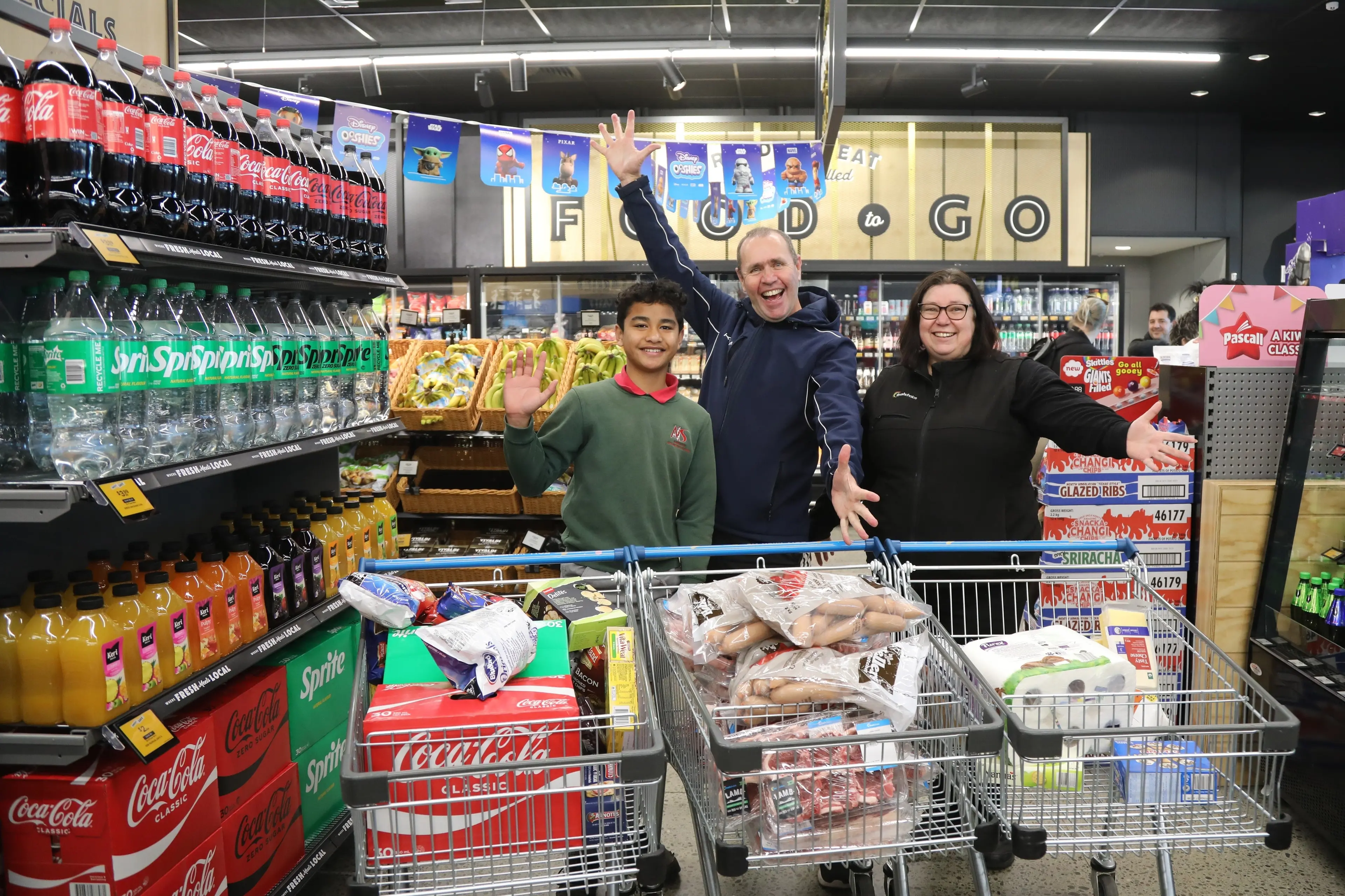 Former Tinwald School pupil, Wiljazariah Bhandari, 12, celebrates his 60-second grocery grab with Tinwald school principal Peter Livingstone and FreshChoice Tinwald Supermarket owner Gaylene Thompson. Photo: Heather Mackenzie